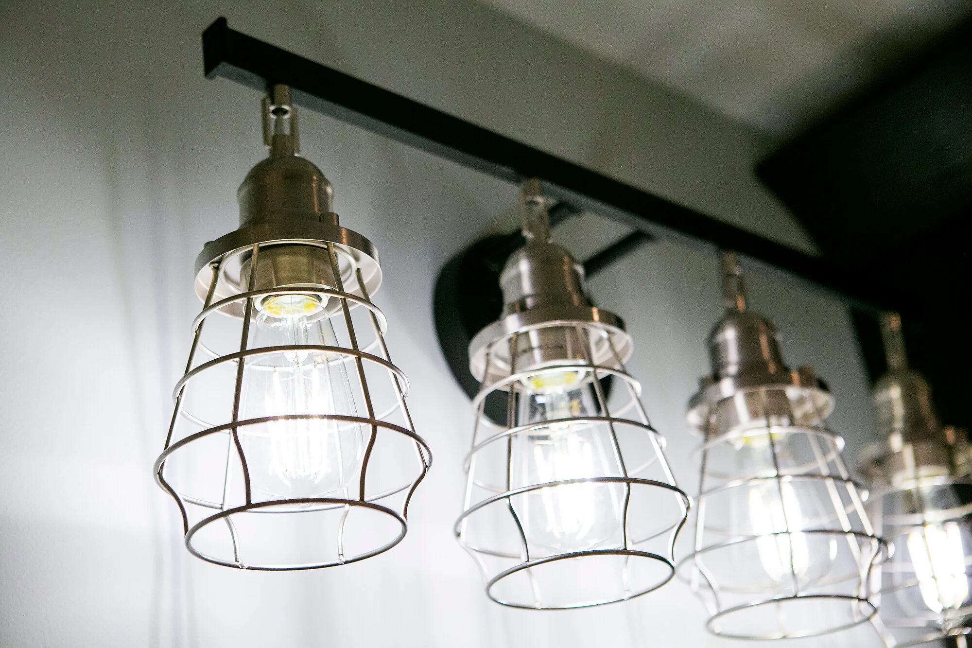  Close-up of caged vanity lights. 