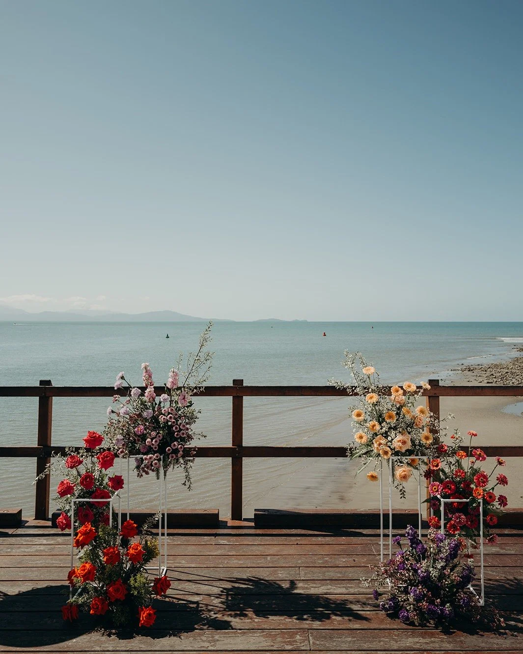 If you are not convinced that a POP of colour is what you need for your Wedding Flowers, check out some more pics of Hannah and Sam's Sugar Wharf wedding. 

This colourful backdrop was not only an amazing Ceremony Backdrop, it also doubled as the per