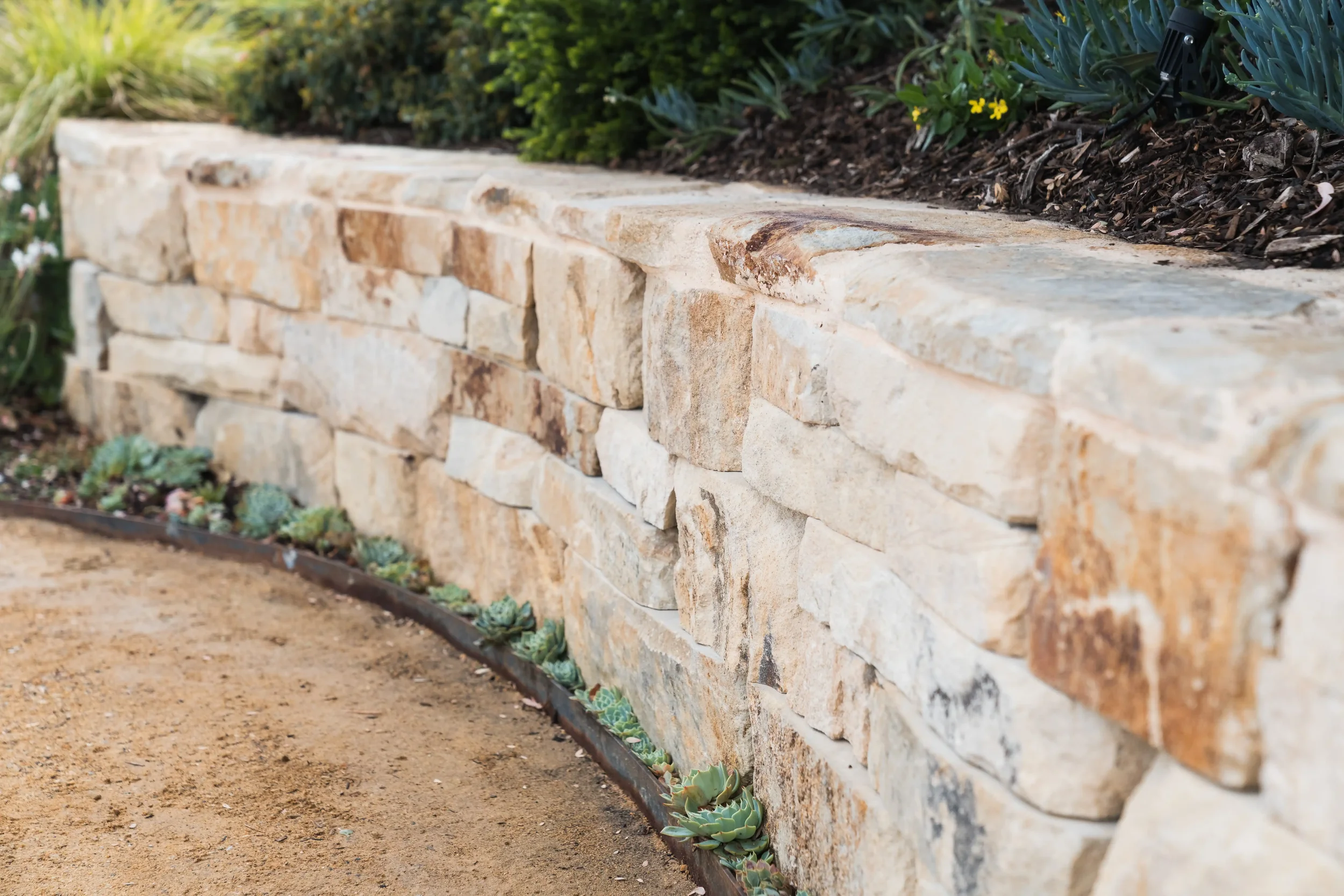 desert-flower-landscaping-adelaide-hills-sandstone-wall-scenic-court-belair.webp