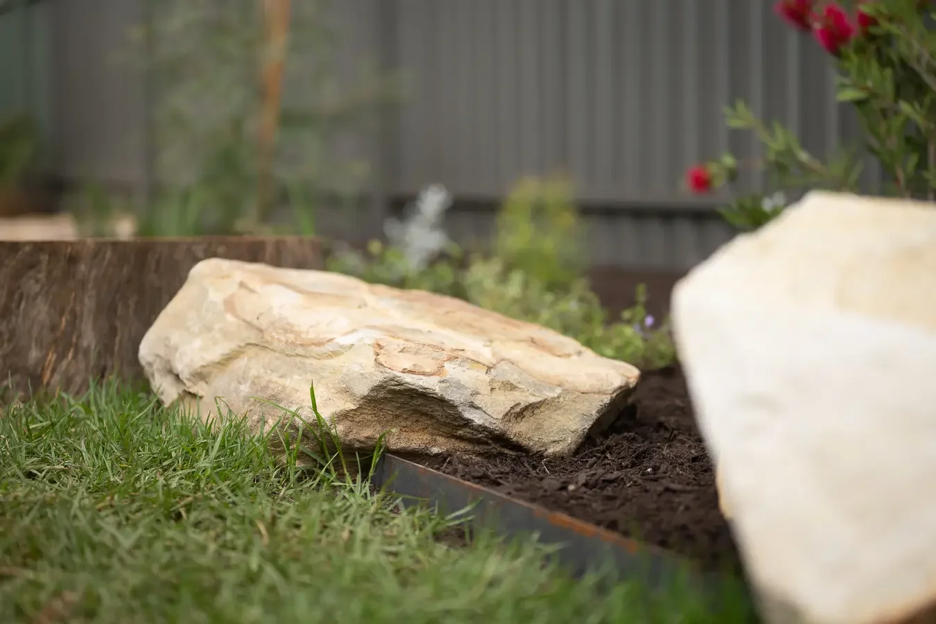 Sandstone boulder and corten steel edging