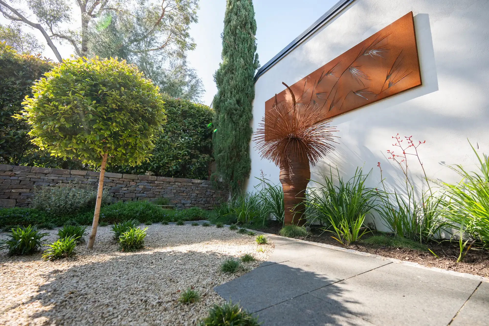 Granite paving with Ross Forknal corten steel sculpture