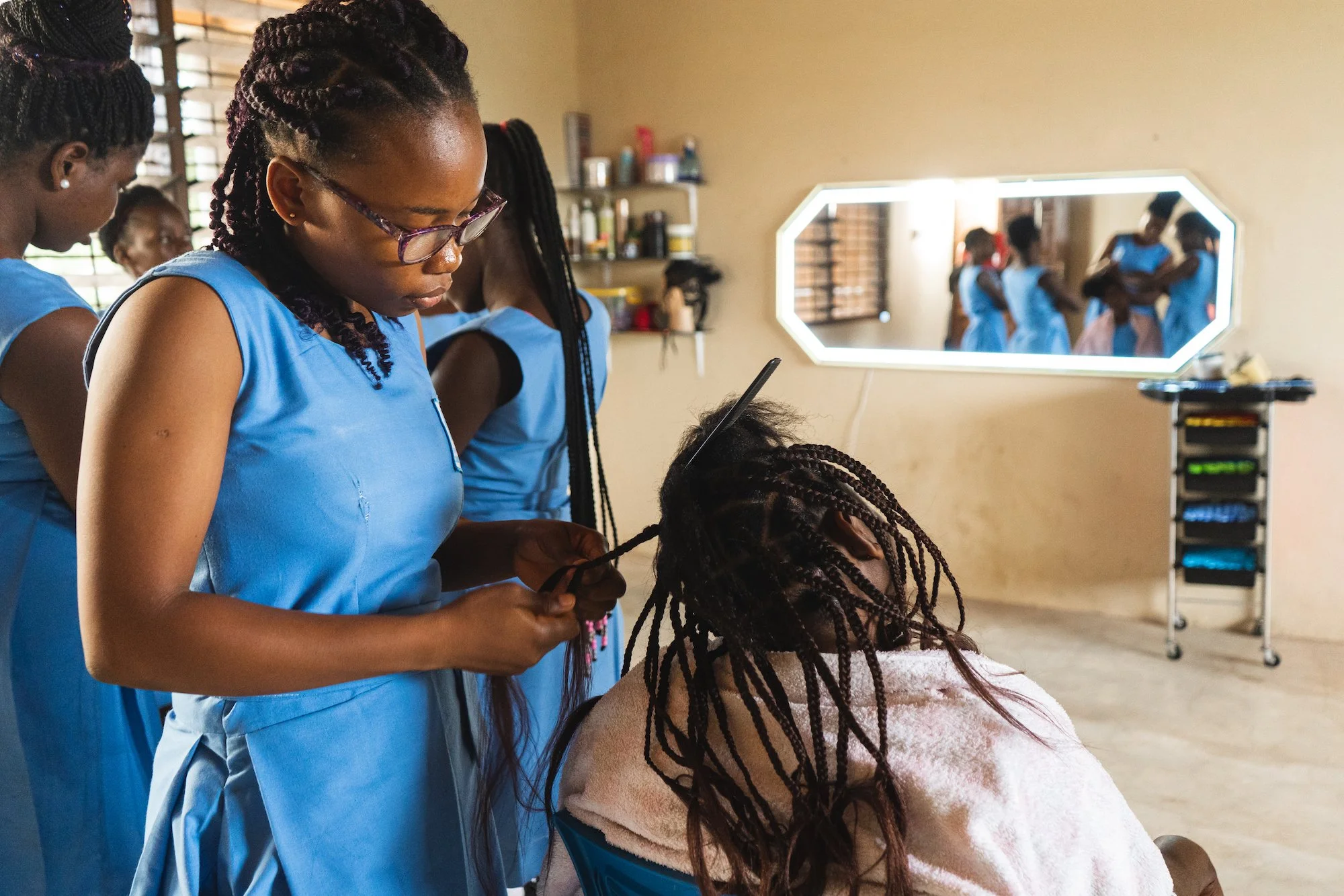 Young women receiving cosmetology training at the Pearl House Career Center
