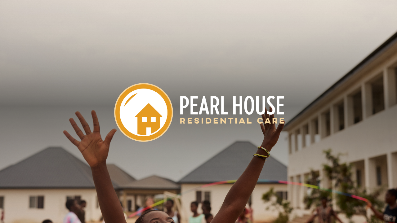 Children playing outside in front of a residential building under a cloudy sky, with a logo and text overlay for Pearl House Residential Care.