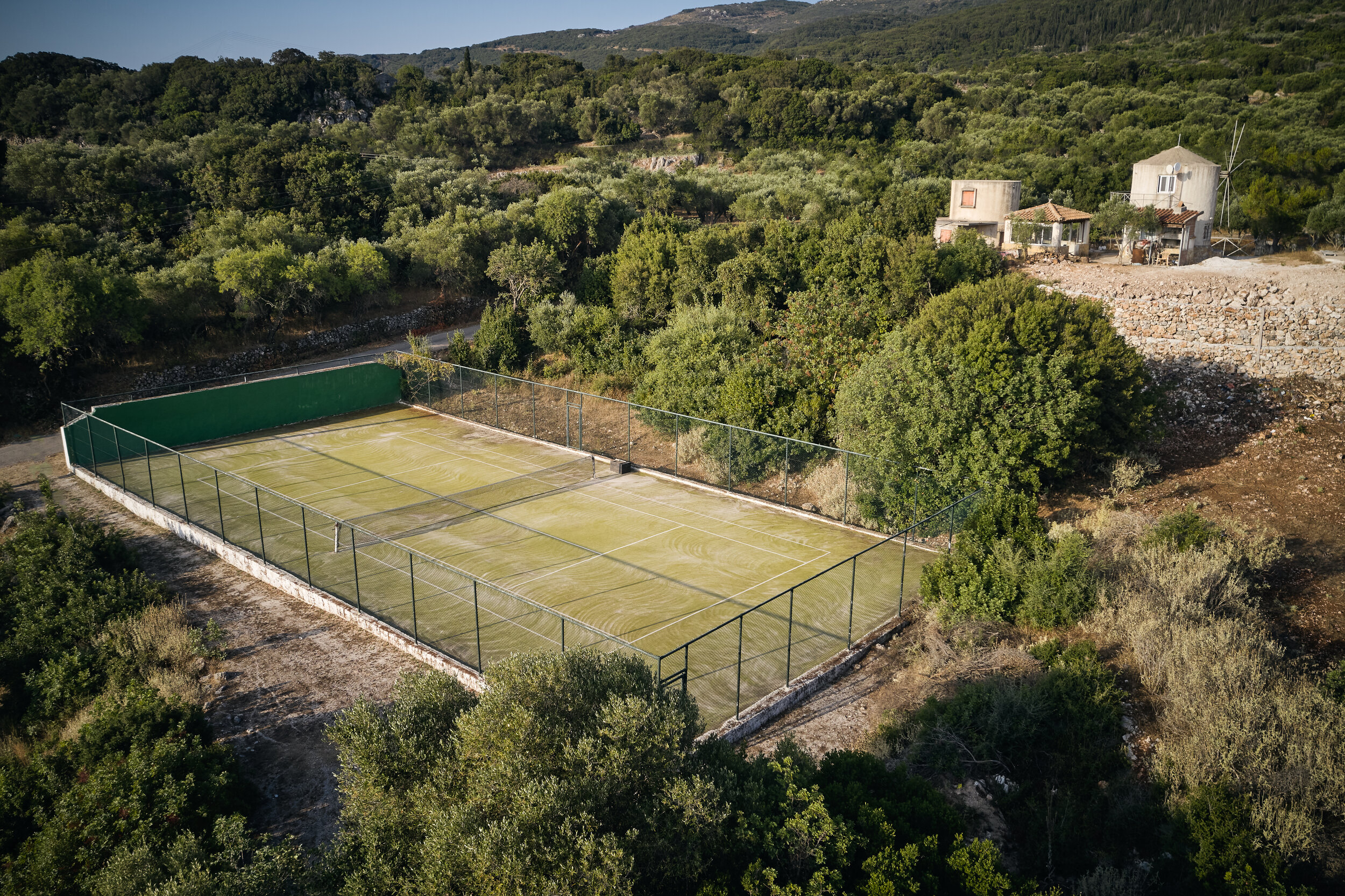 Private tennis court amongst ancient olives