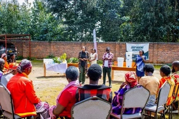 Josue, pictured at the center, engages families in a conversation about nutrition and hygiene—grounding the data in the people, experiences, and relationships behind every number.