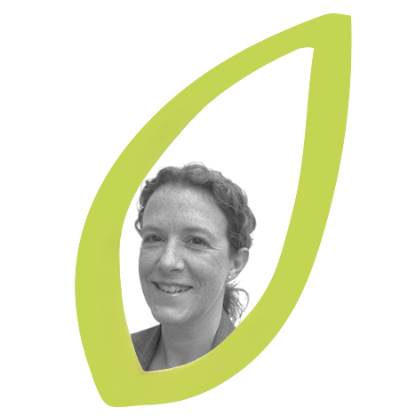 Jo. Black and white portrait of a woman with curly hair, smiling, surrounded by a lime green leaf-shaped outline.