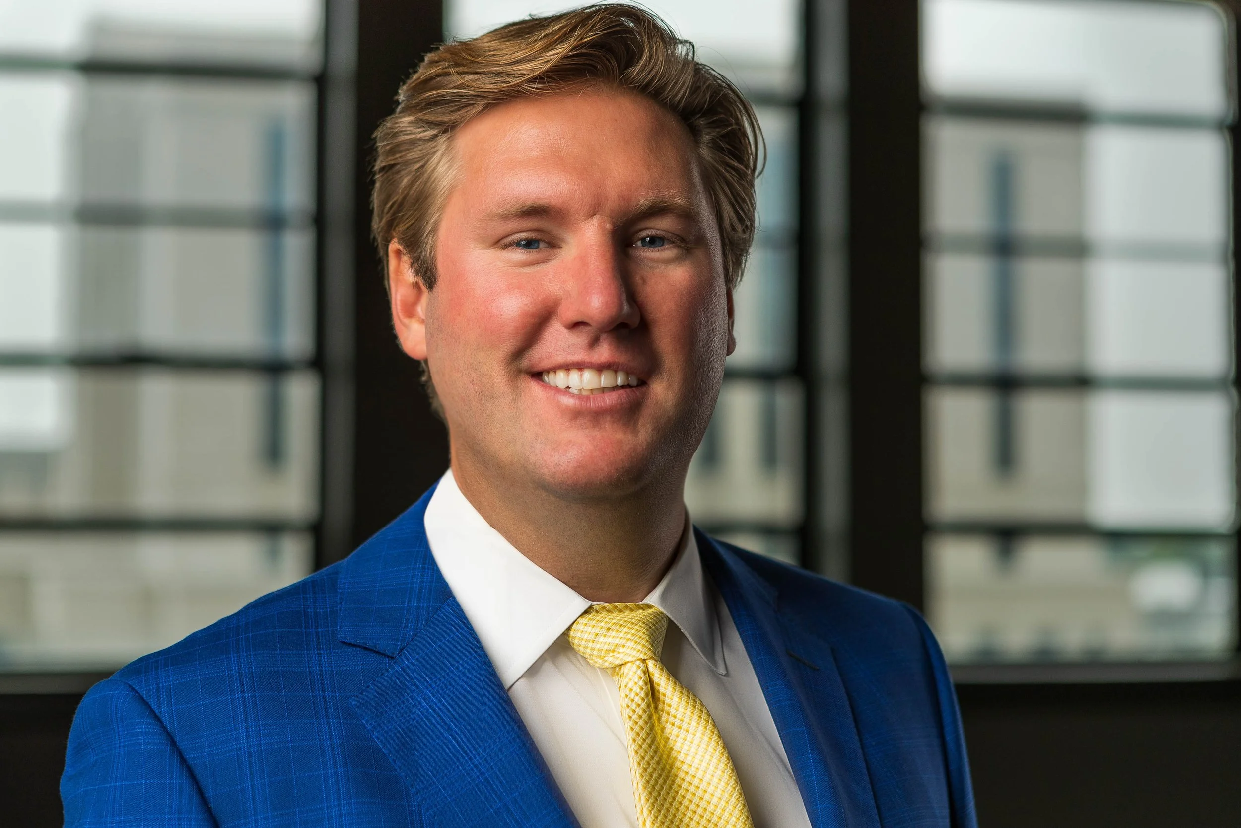 Professional portrait of business executive inside Greenville, South Carolina office — corporate photography and law firm brand photography by Weaver Media.