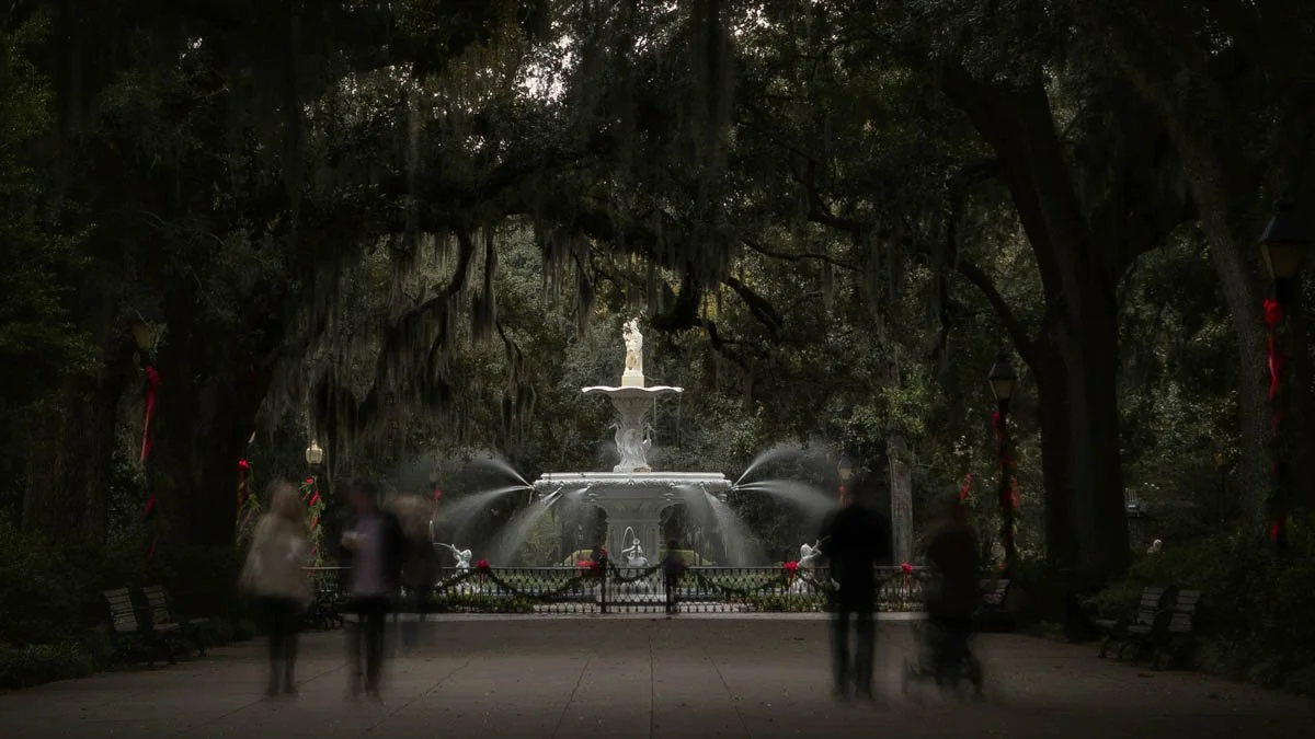Forsyth Park Fountain, in Historic Savannah, Georgia, surrounded by oak trees and Spanish moss — cinematic landscape photography by Weaver Media