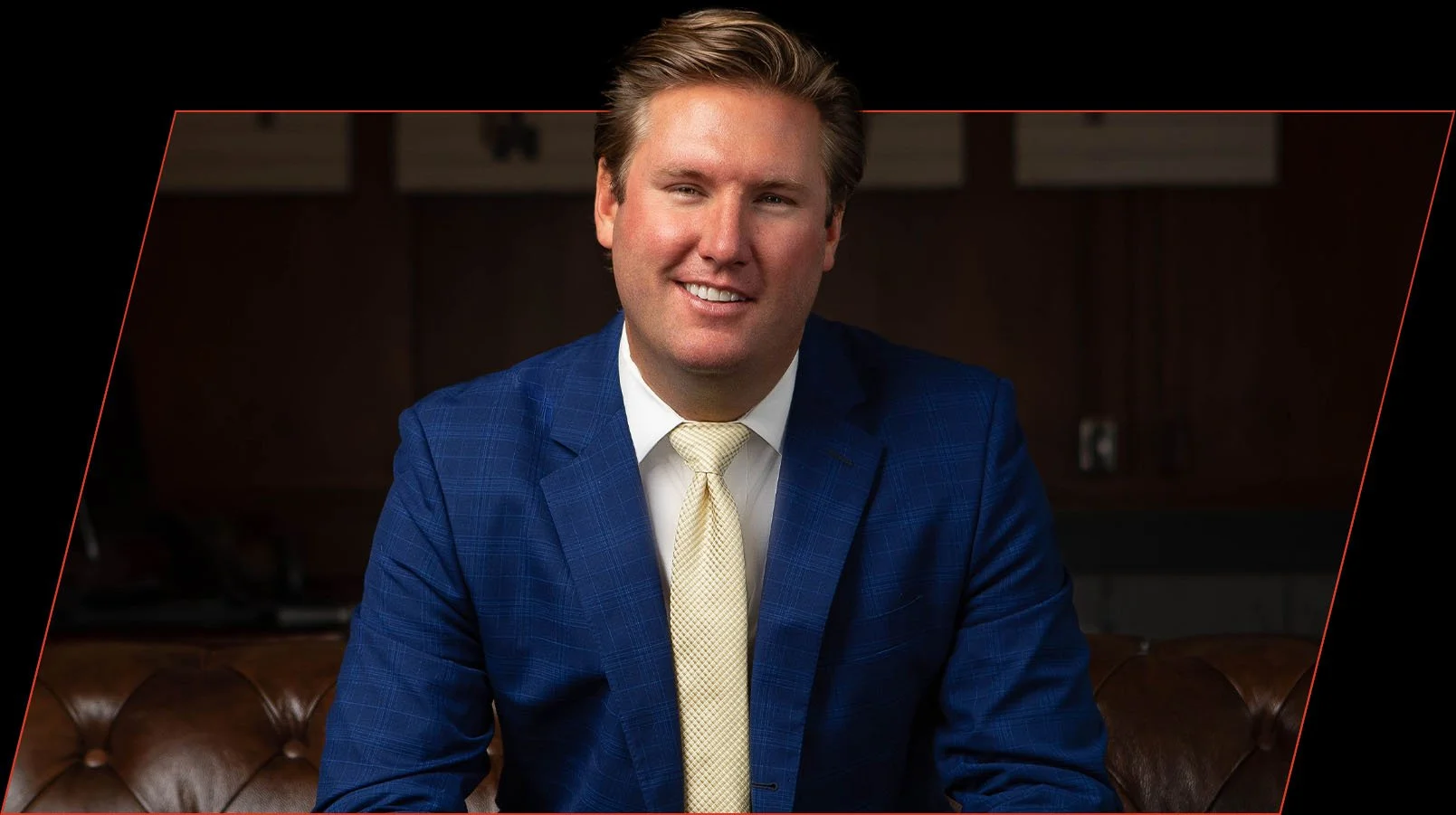 Testimonial portrait of Aaron A smiling in a blue suit