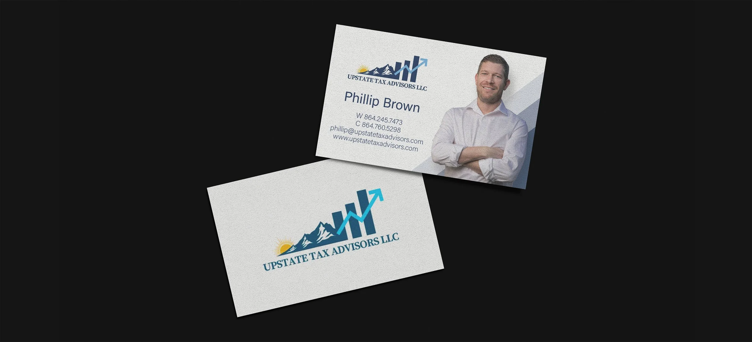 Business card for Phillip Brown from Upstate Tax Advisors LLC, featuring a logo with a mountain and sunrise, along with contact information and a professional photo of Phillip Brown smiling with arms crossed.