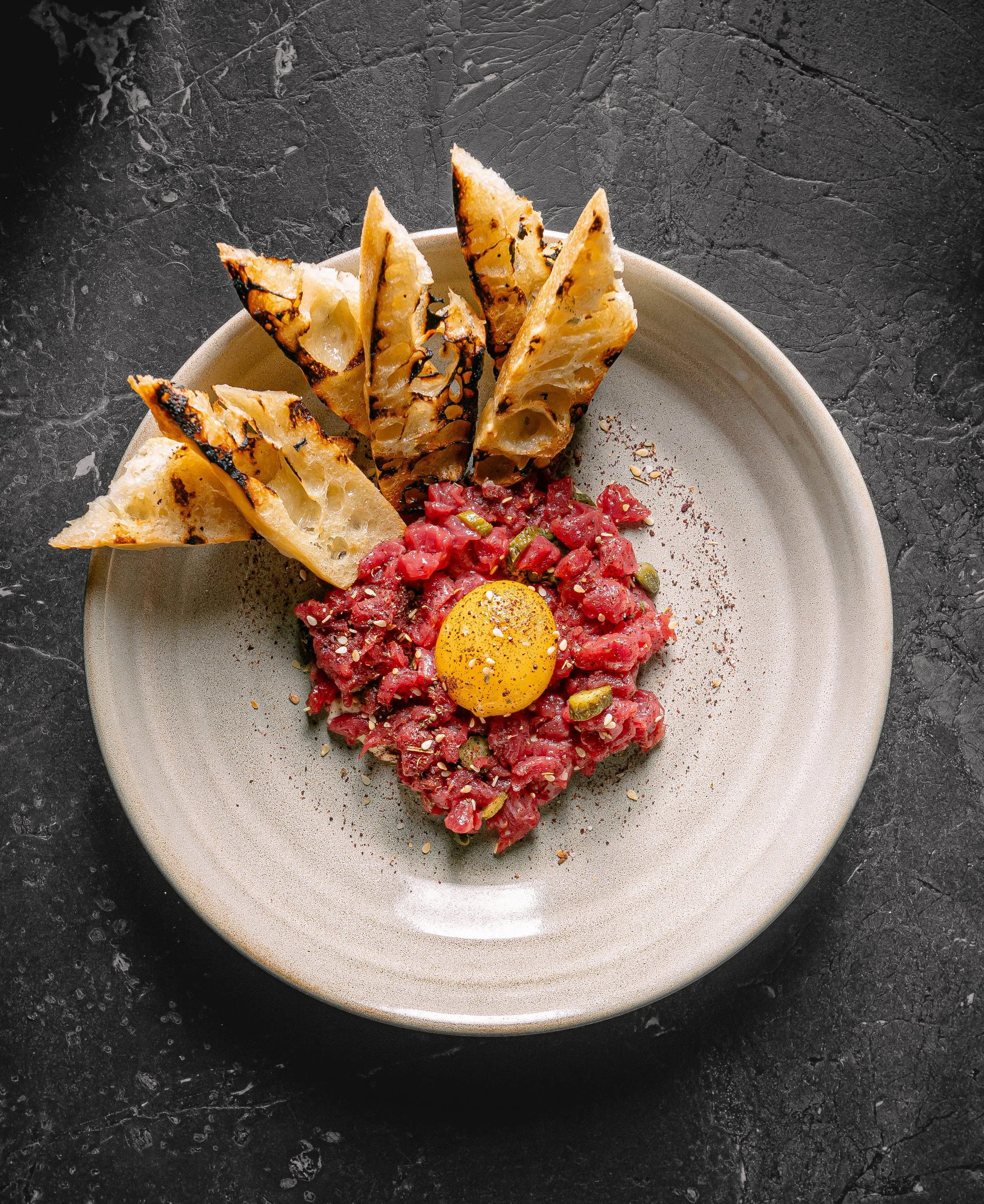 Ceviche with egg yolk and toasted bread served at Curean Mediterranean restaurant in Greenville, South Carolina — gourmet food photography by Weaver Media