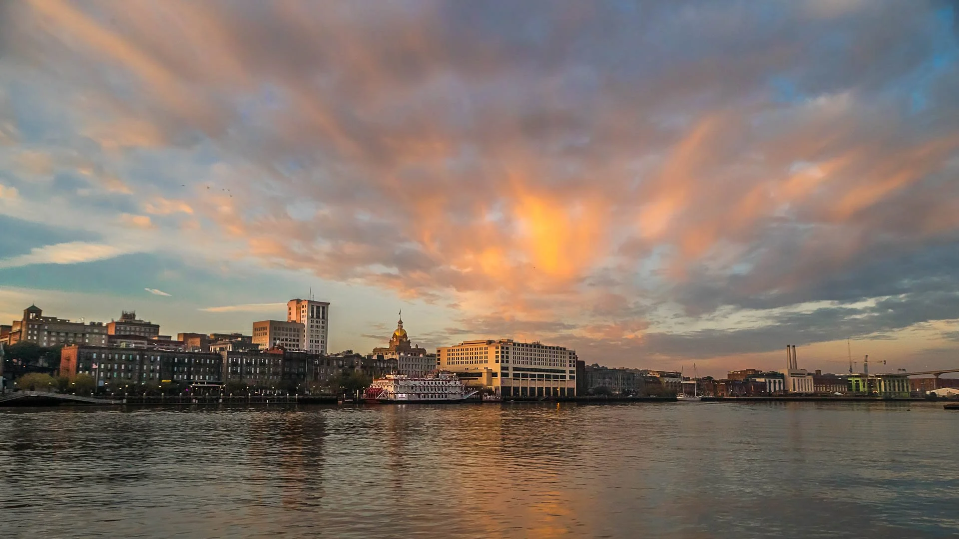 Savannah, Georgia skyline at sunrise with reflections over water — cinematic cityscape photography by Weaver Media