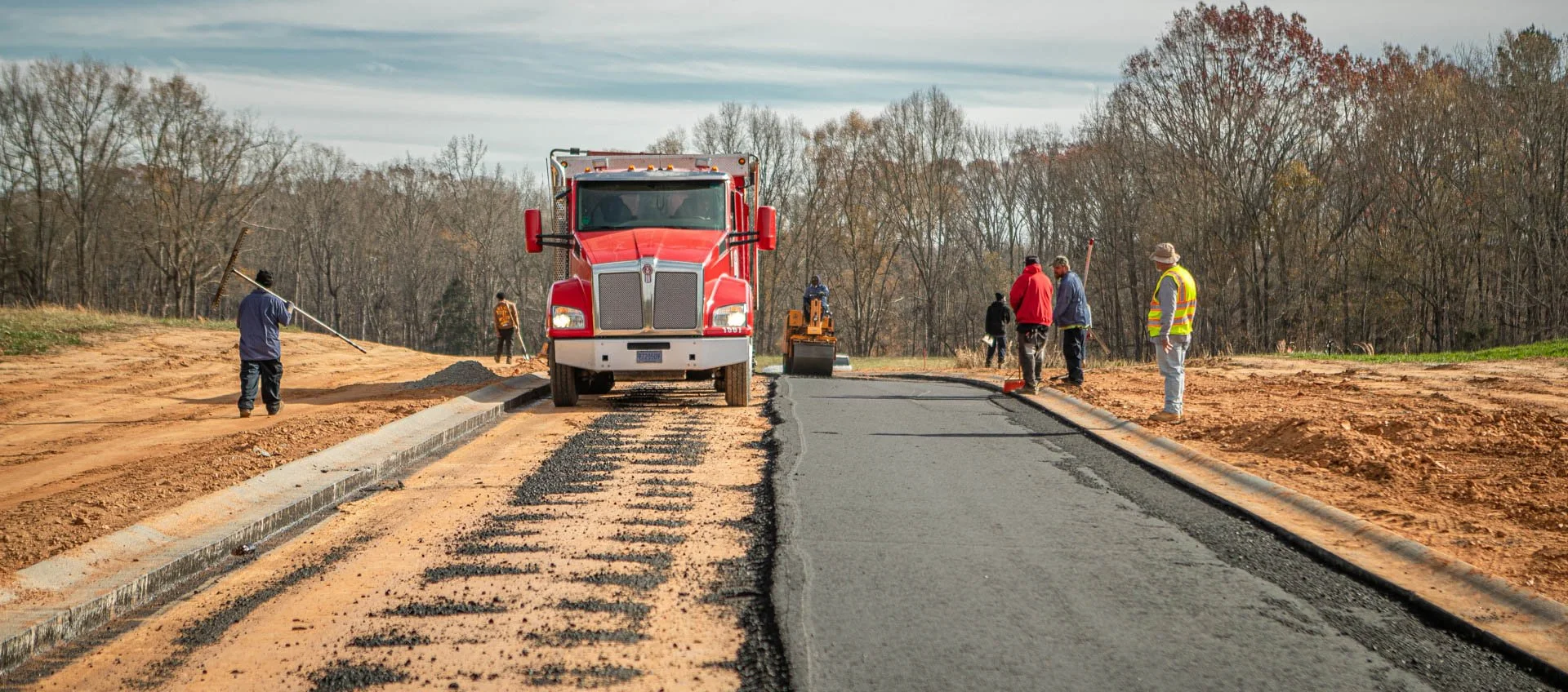 Road paving crew working on commercial development project by Lassiter Taylor Construction in Greenville, South Carolina — construction photography