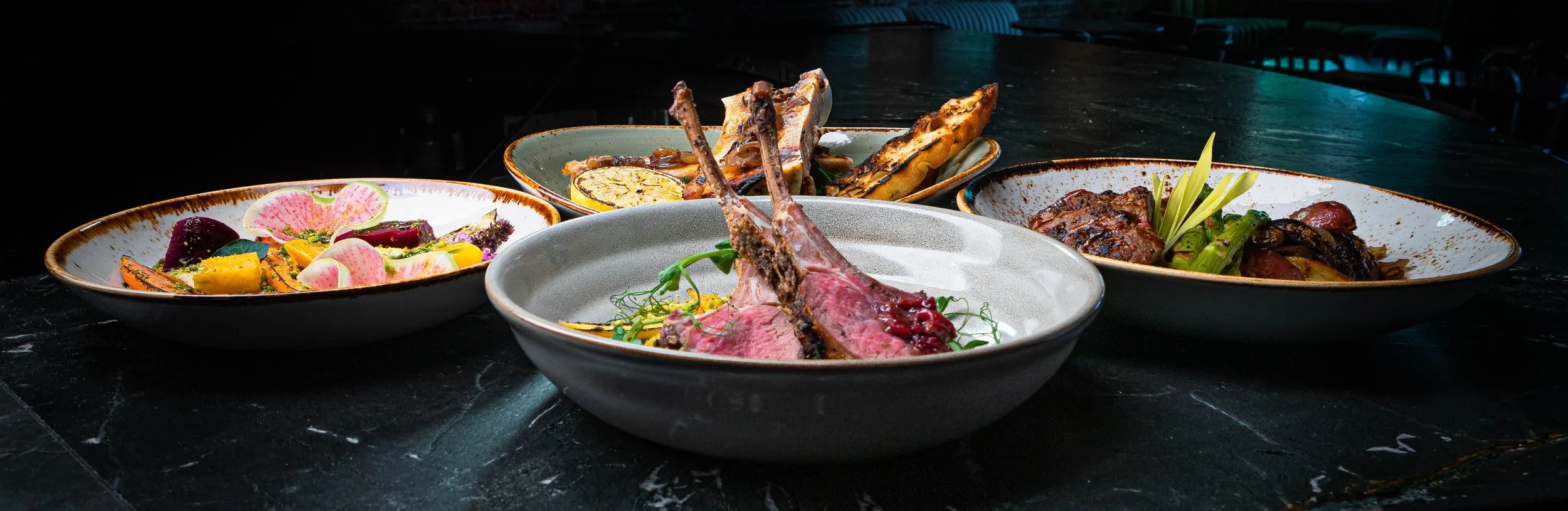 Mediterranean dishes including lamb chops, vegetables and more served at Curean restaurant in Greenville, SC — gourmet food photography by Weaver Media