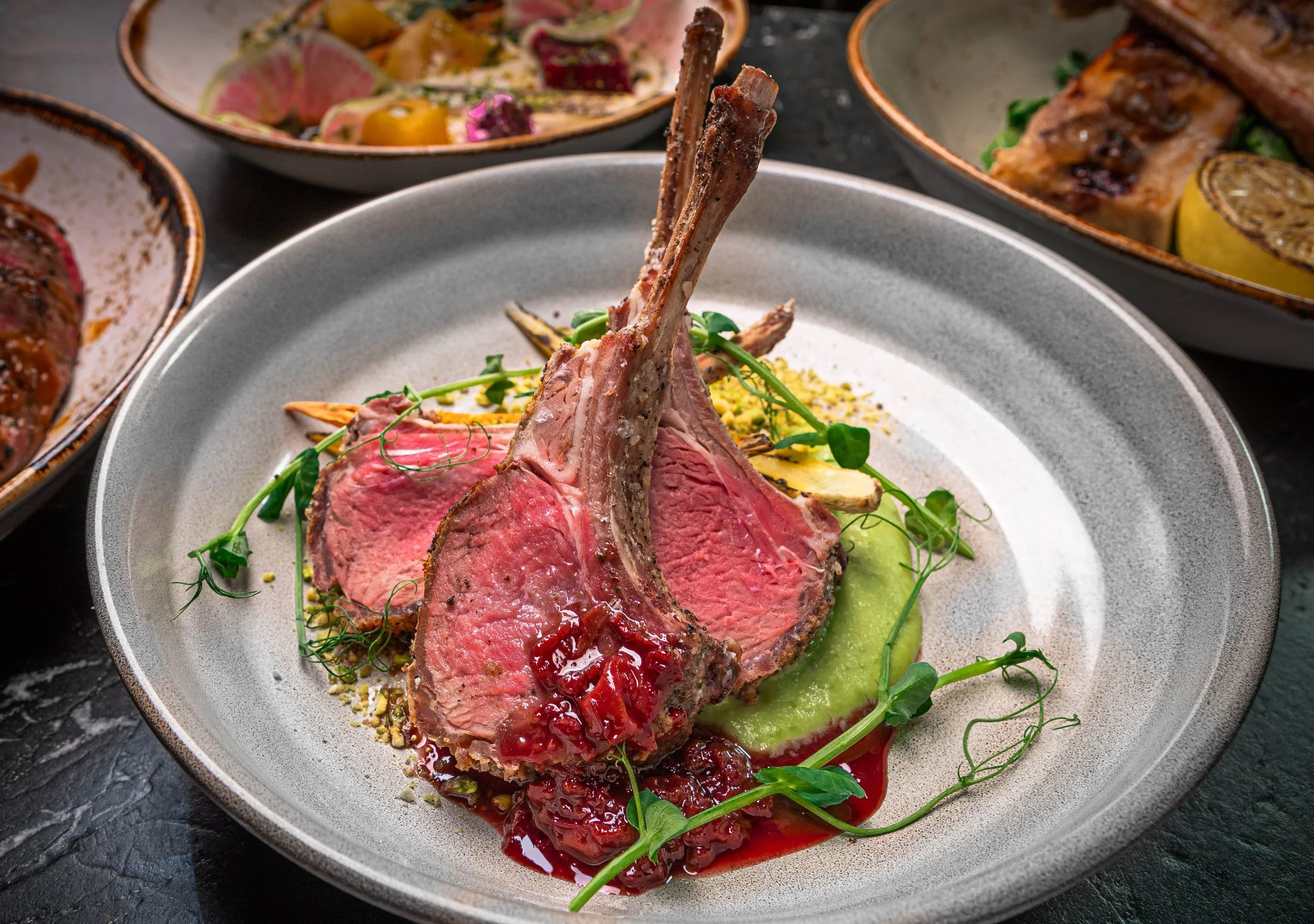 Rack of lamb entrée with roasted vegetables served at Curean Mediterranean restaurant in Greenville, South Carolina — gourmet food photography by Weaver Media