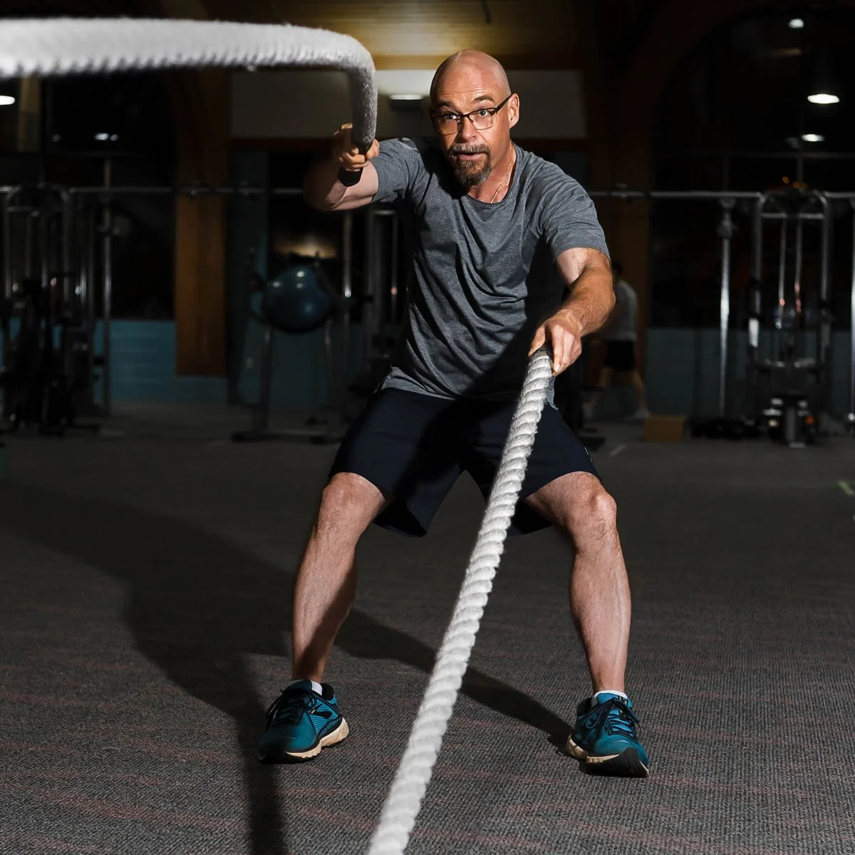 Michael Thomerson, managing attorney of Thomerson Jones & Edwards P.C. training with battle ropes in Greenville gym — lifestyle brand storytelling photography by Weaver Media