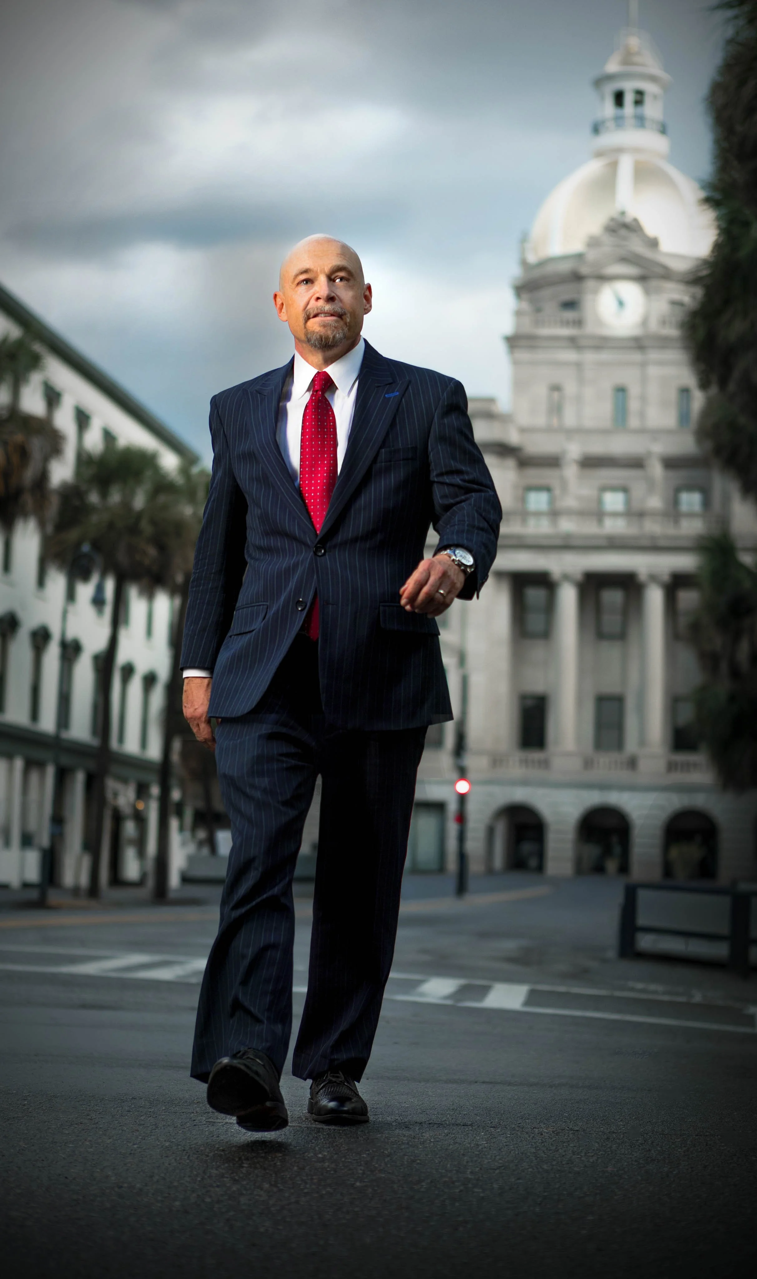 Business attorney Michael Thomerson, managing attorney of Thomerson Jones & Edwards P.C. walking through Savannah, Georgia in front of City Hall— law firm brand photography by Weaver Media