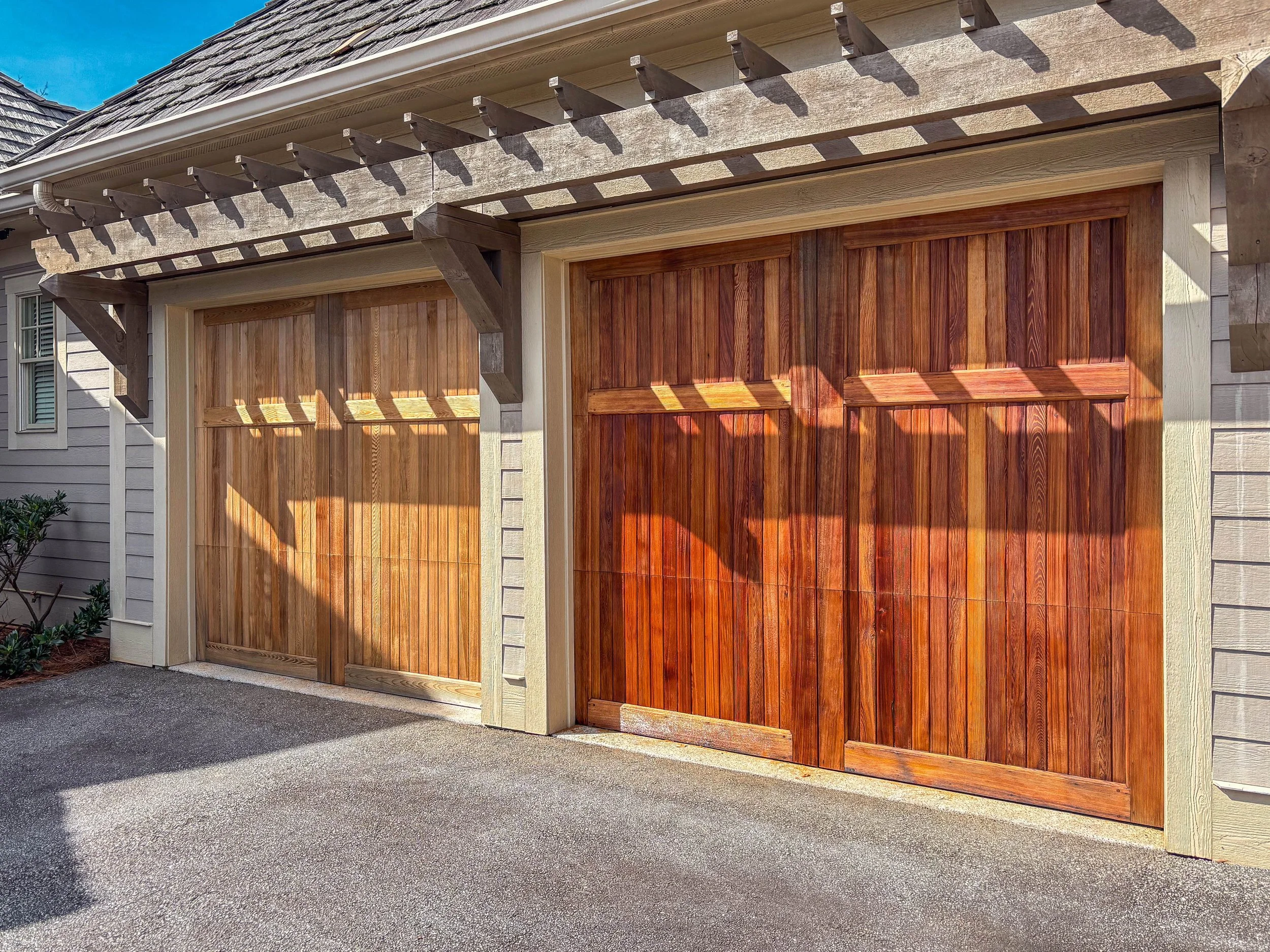 Residential home in The Reserve on Lake Keowee with freshly stained wood garage doors and paved driveway in Greenville, South Carolina — architectural home photography