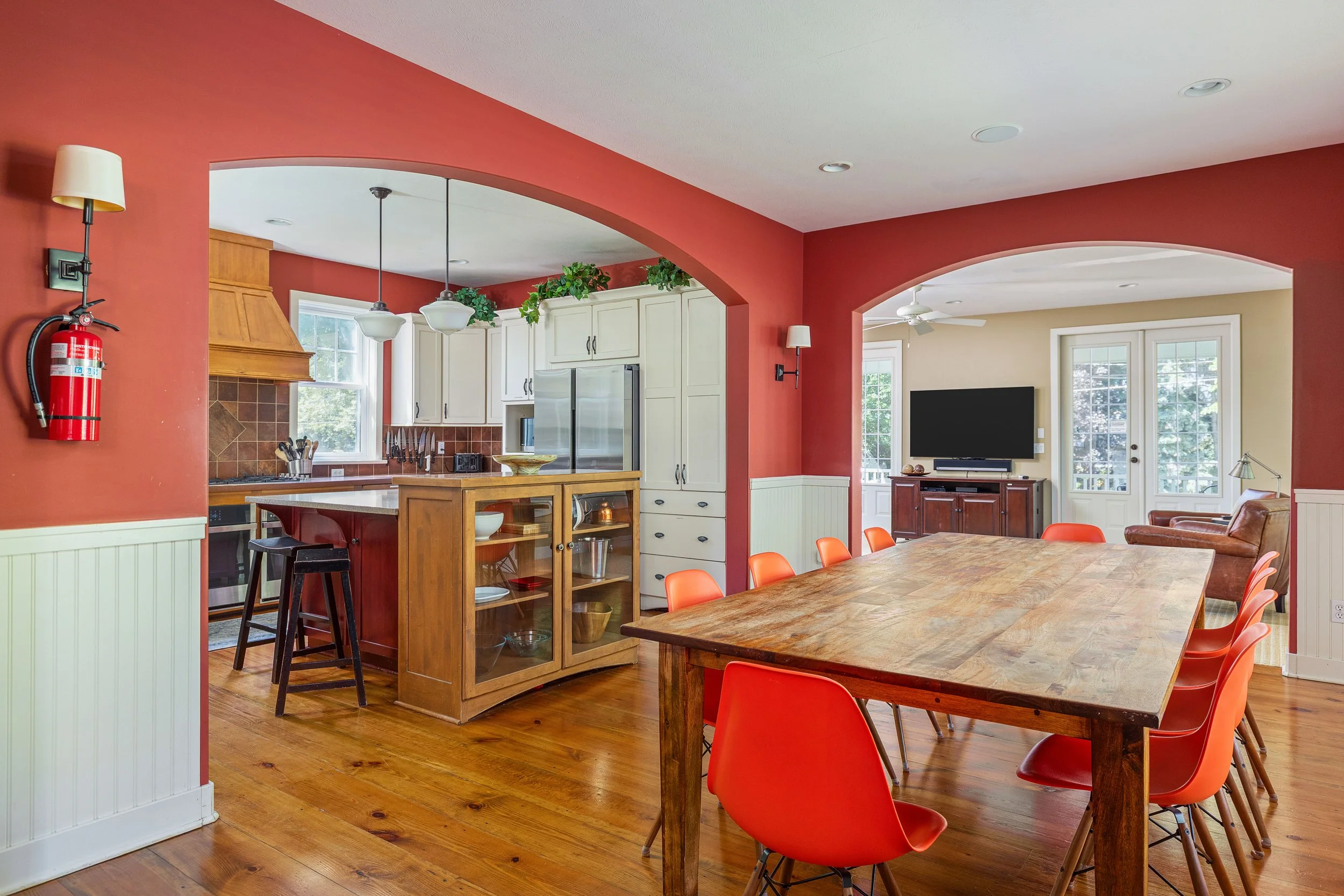 The dining room features a large farmhouse dining table, and is right next to the kitchen