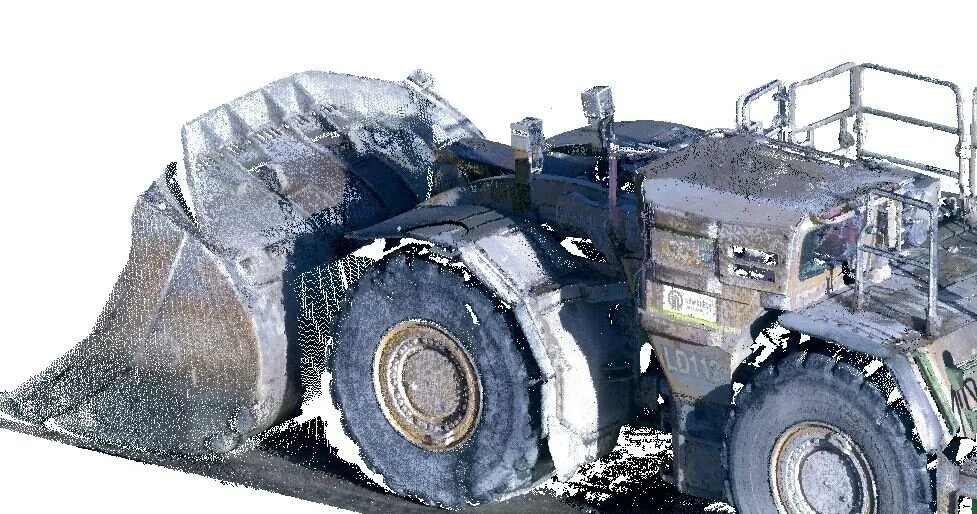 A large industrial snow blowing machine with a wide intake and heavy-duty tires.