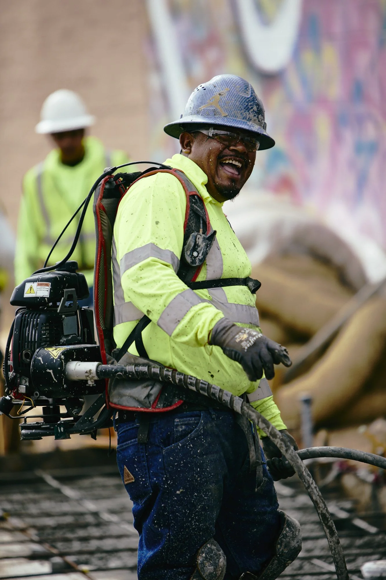 Concrete worker with backpack vibrator
