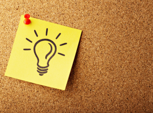 important information icon yellow sticky note with a lightbulb icon pinned to a corkboard