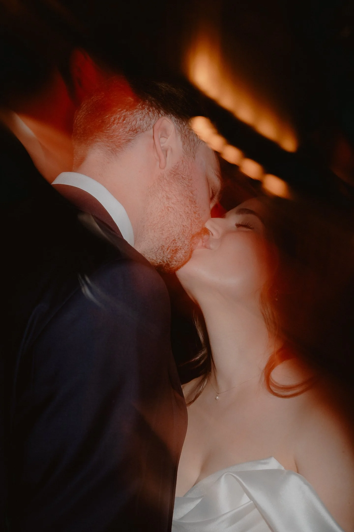 Bride and Groom kiss on the dancefloor - candid photography by Leeds wedding photographer photoJMO