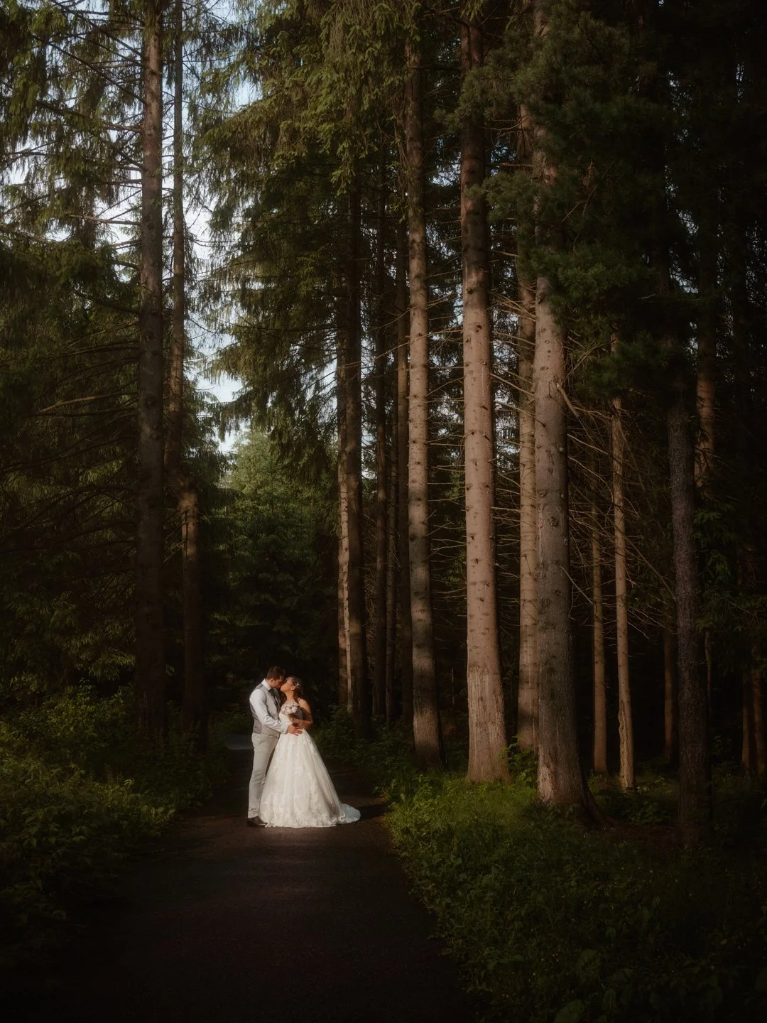 Bride and Groom embrace in the woods on their wedding day, photographed by London Wedding Photographer photoJMO