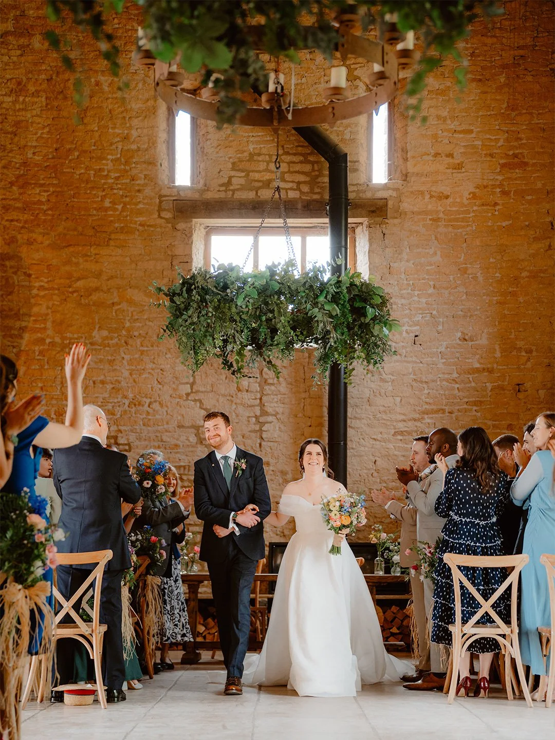Bride and Groom walking down the aisle at Old Gore Barn, Cirencester - photographed by photoJMO