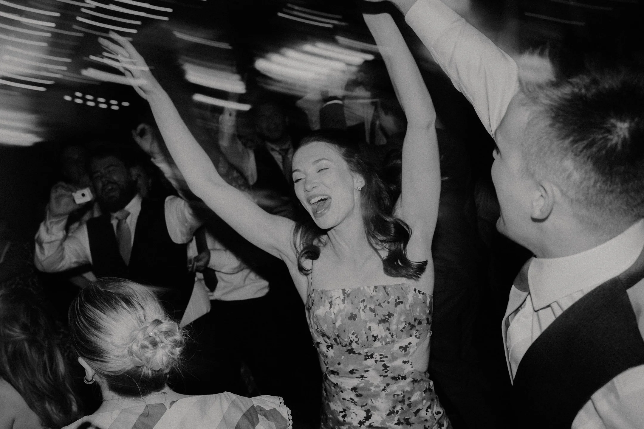 Candid dancefloor photography at a wedding - a woman dancing