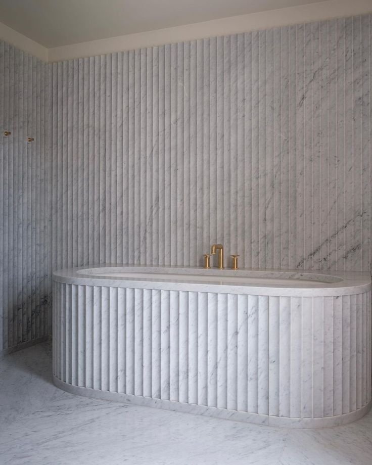 fluted marble tub and wall.jpg