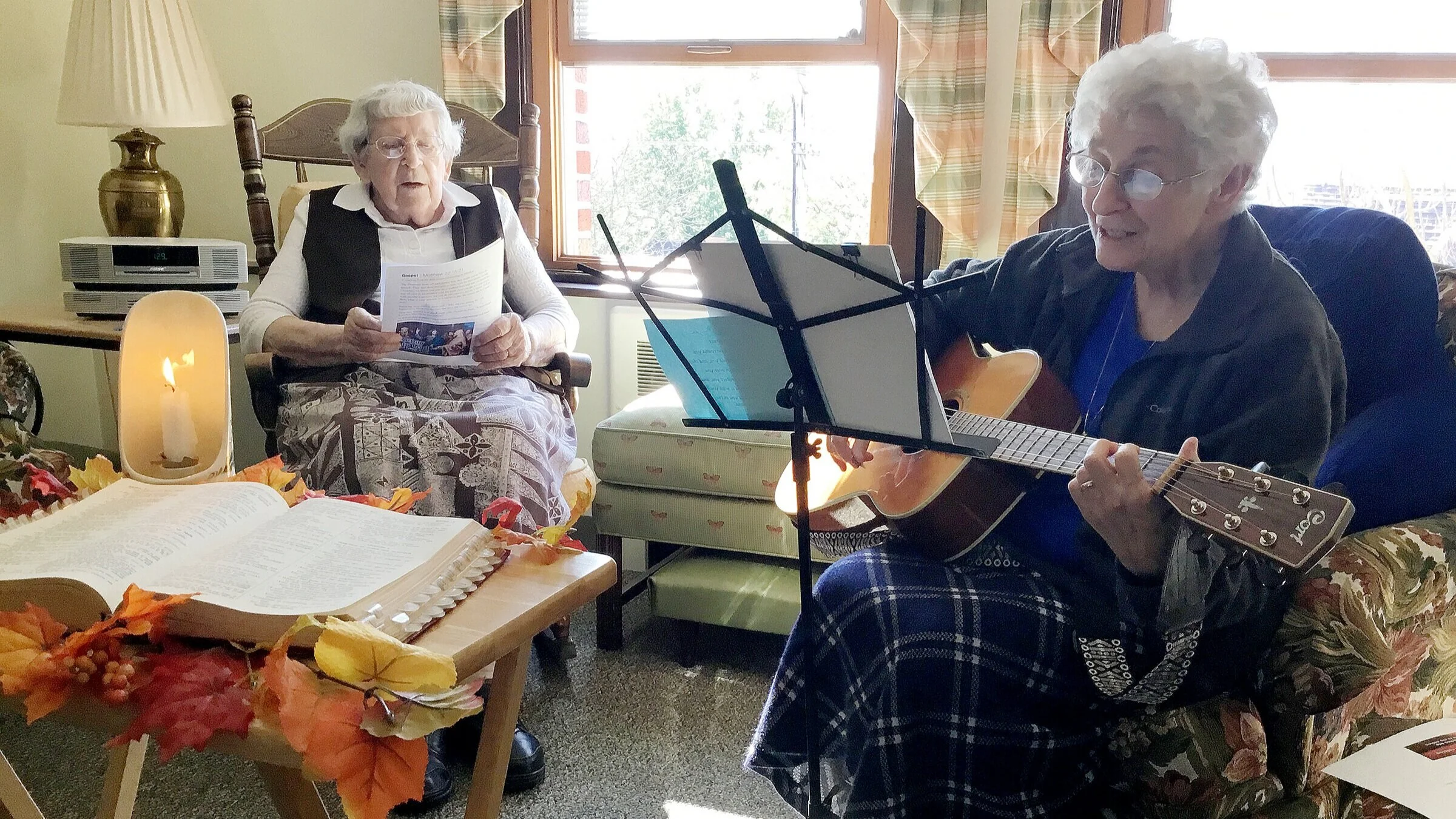 Sister Norberta Kralosky sings along as Sister Georgette Dublino plays guitar during a pre-pandemic gathering of Sisters at Mt. Assisi Place in Pittsburgh.