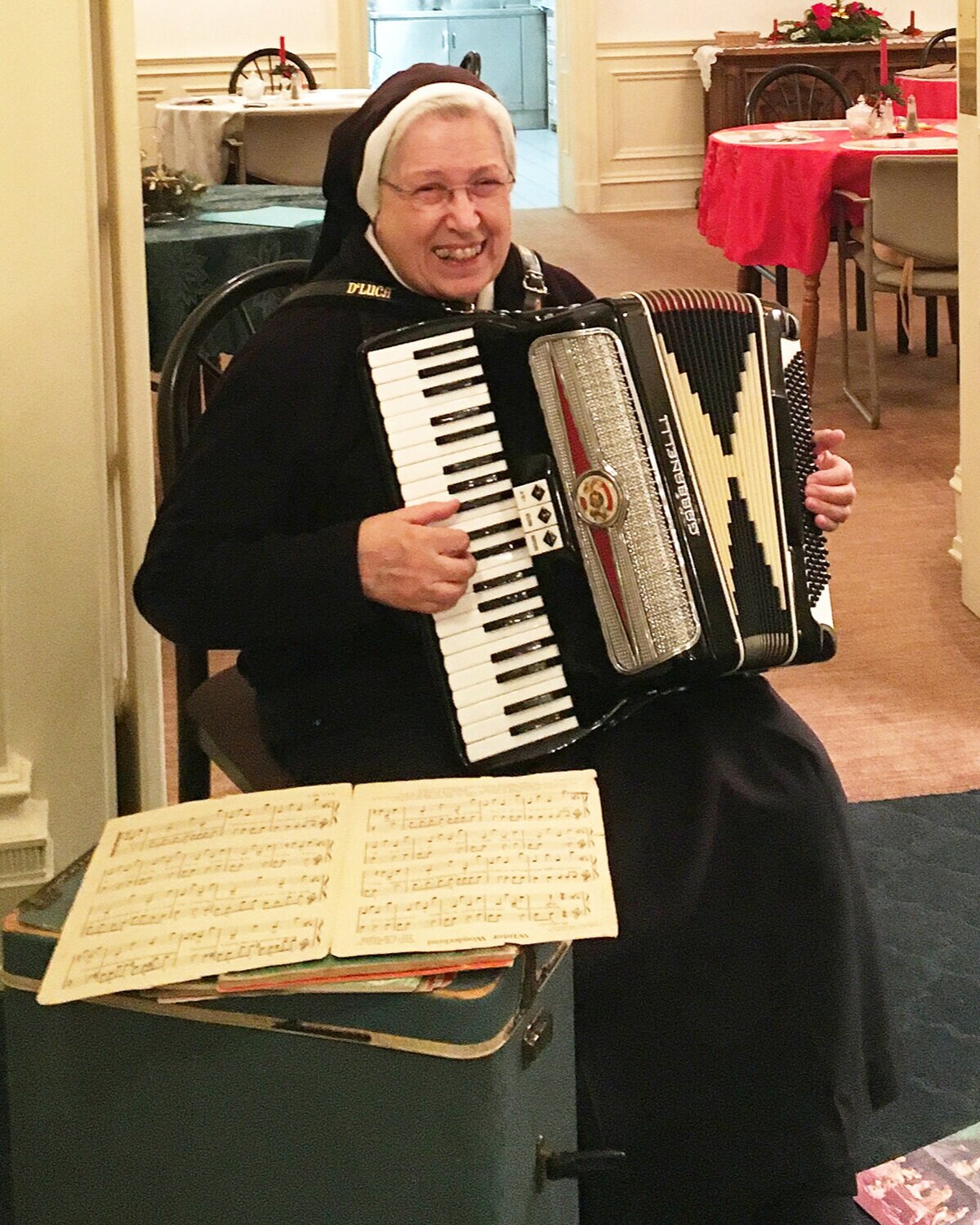Sister Mary Martha Zammatore and her accordion make a joyful musical connection during the holiday season at Monocacy Manor in Bethlehem, Pa.