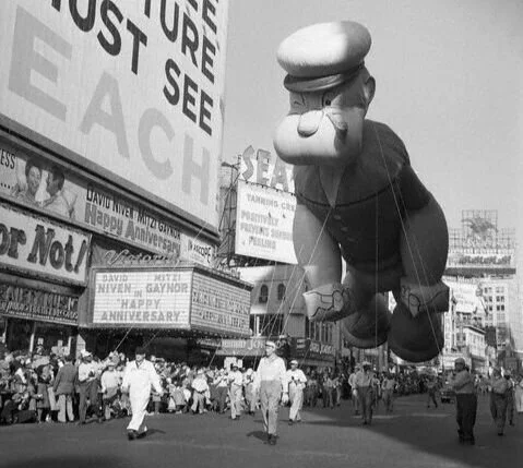 Popeye makes his way through Times Square in New York City as part of the 1958 Macy’s Thanksgiving Day Parade.