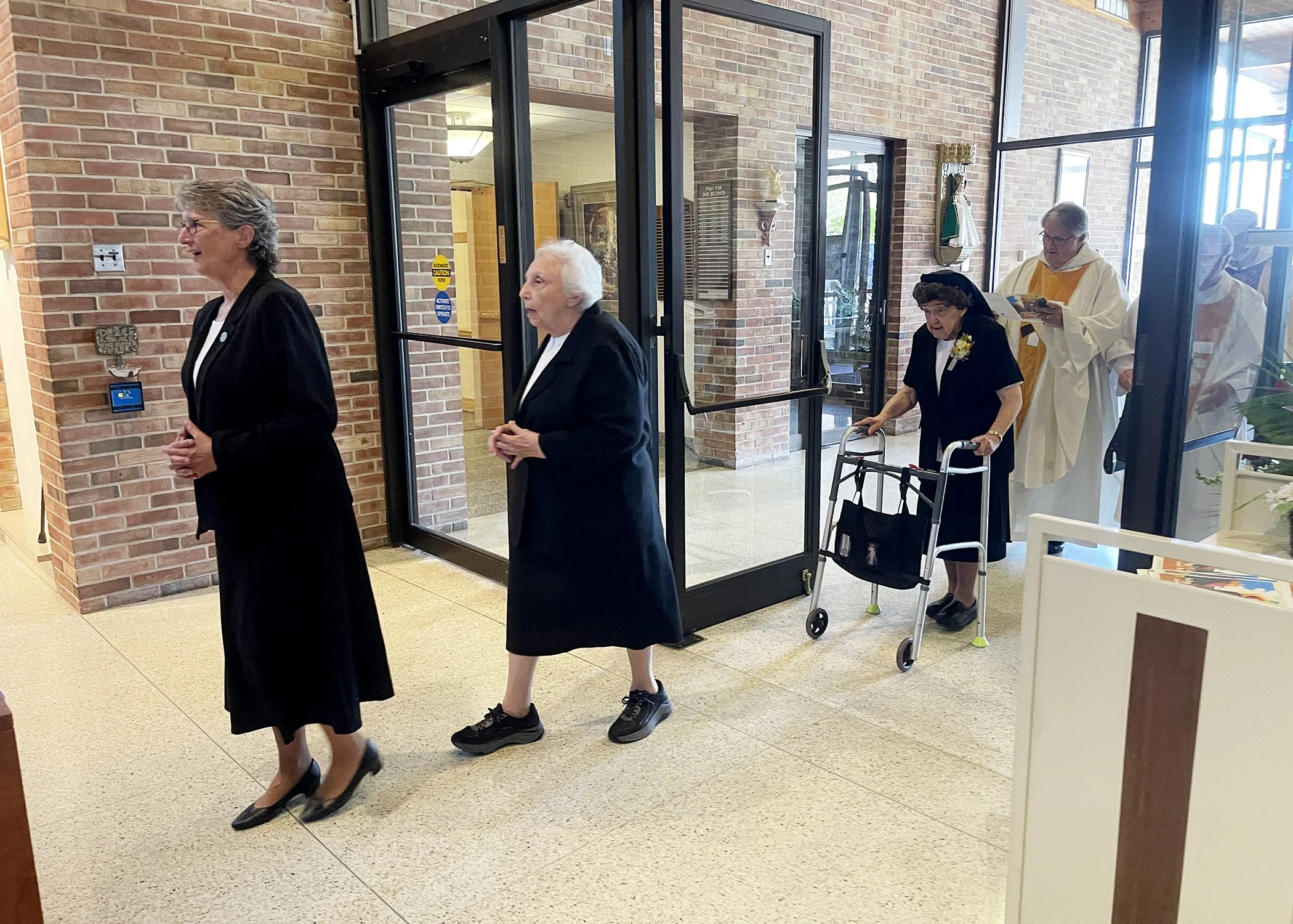  Sister Bonnie Marie Kleinschuster and Mary Xavier Bomberger process into the chapel for Sister Cecilia Jacko's 75th Jubilee Mass at Mt. Assisi Place on July 13, 2024. 