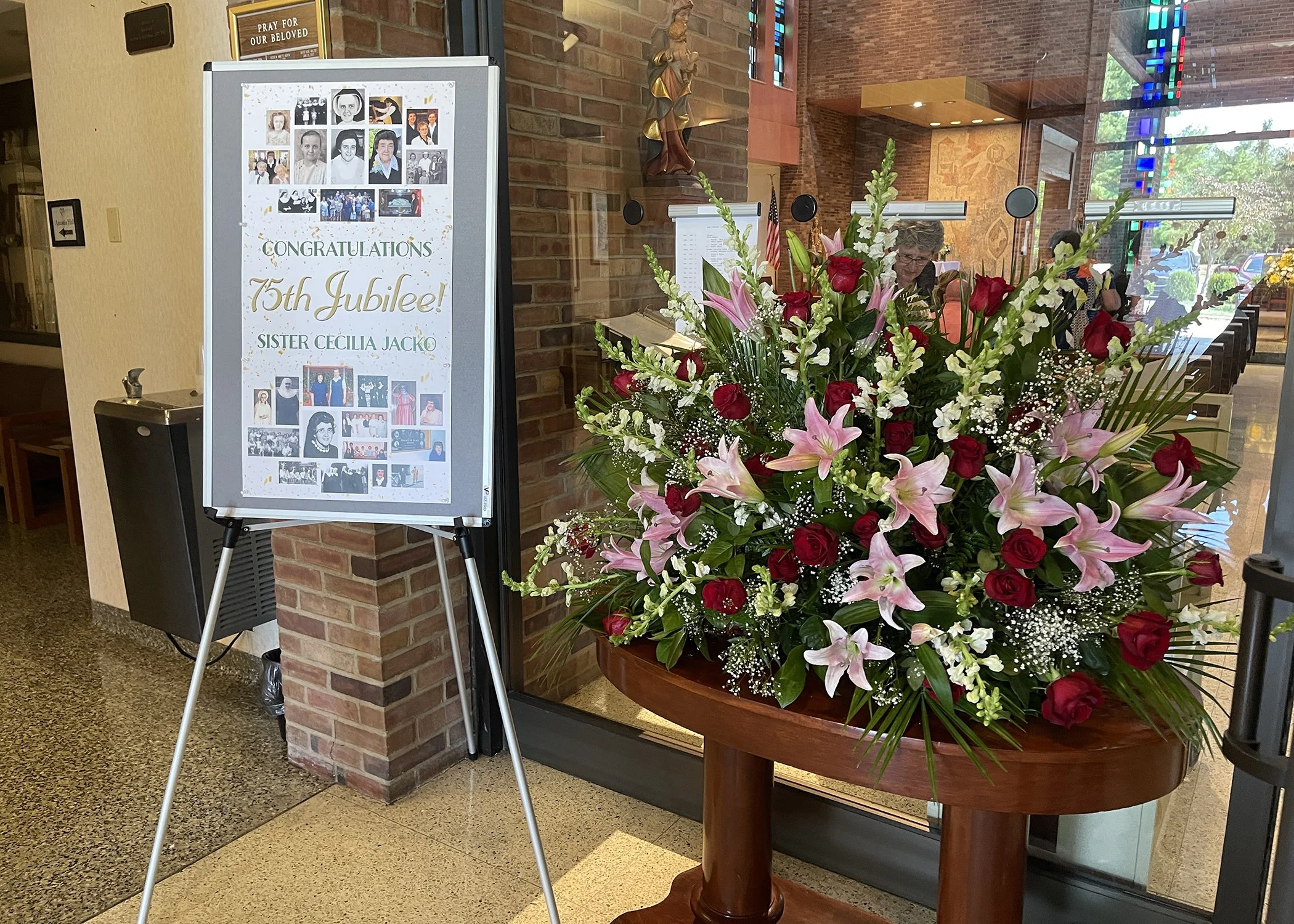  Flowers and celebratory signage greet guests of Sister Cecilia Jacko's 75th Jubilee Mass at Mt. Assisi Place on July 13, 2024. 