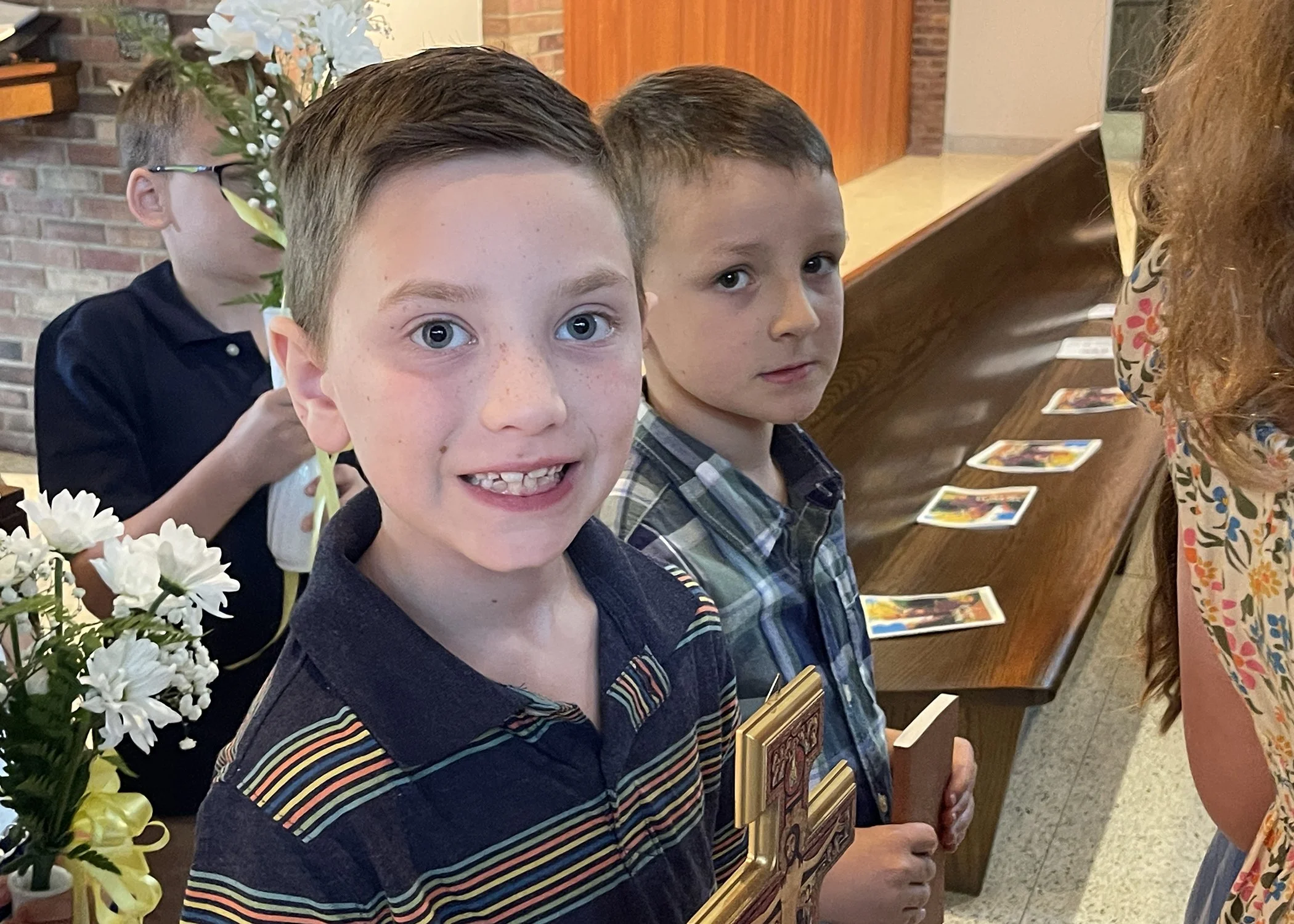  Quinn Dallvechio and Wesley Russell, great-great nephews of Sister Cecilia Jacko, participate in the offertory procession during Sister's 75th Jubilee Mass on July 13, 2024. 