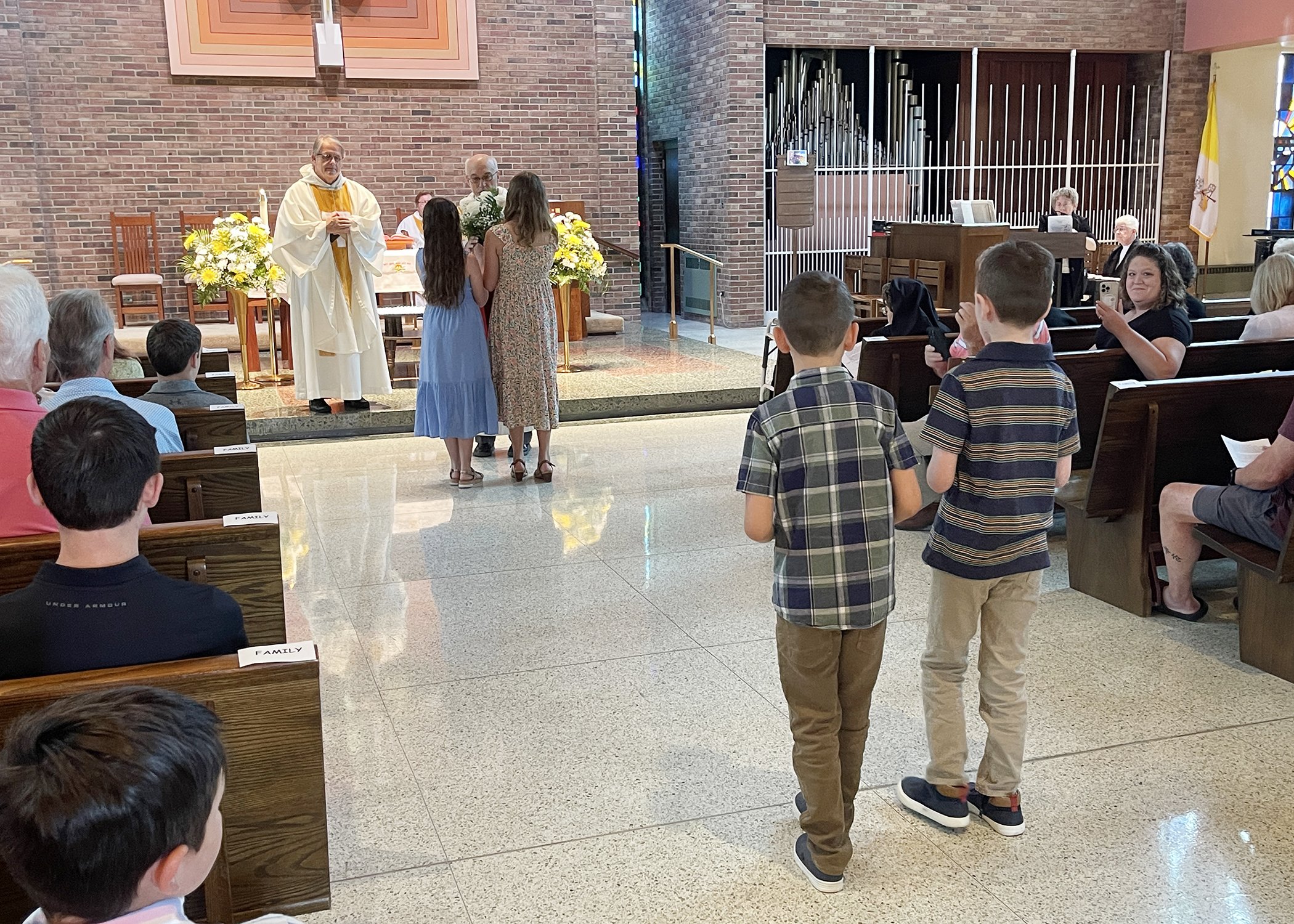  Young members of the Jacko Family form the offertory procession during Sister Cecilia Jacko's 75th Jubilee Mass on July 13, 2024. 