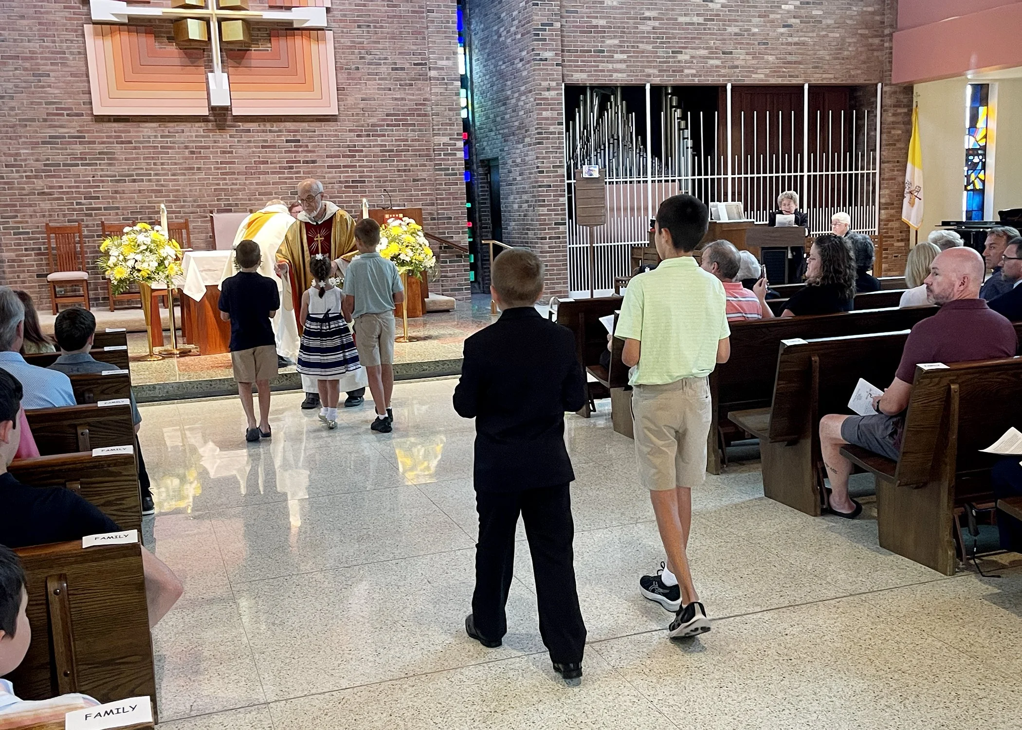  Young members of the Jacko Family form the offertory procession during Sister Cecilia Jacko's 75th Jubilee Mass on July 13, 2024. 