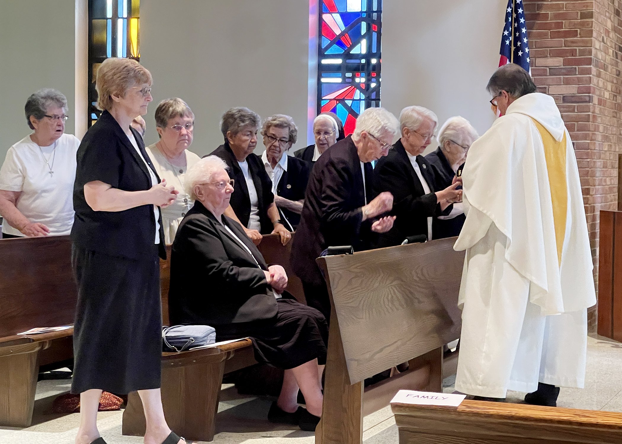  Members of the School Sisters of St. Francis receive Communion from Father John Bachkay during Sister Cecilia Jacko's 75th Jubilee Mass on July 13, 2024. 