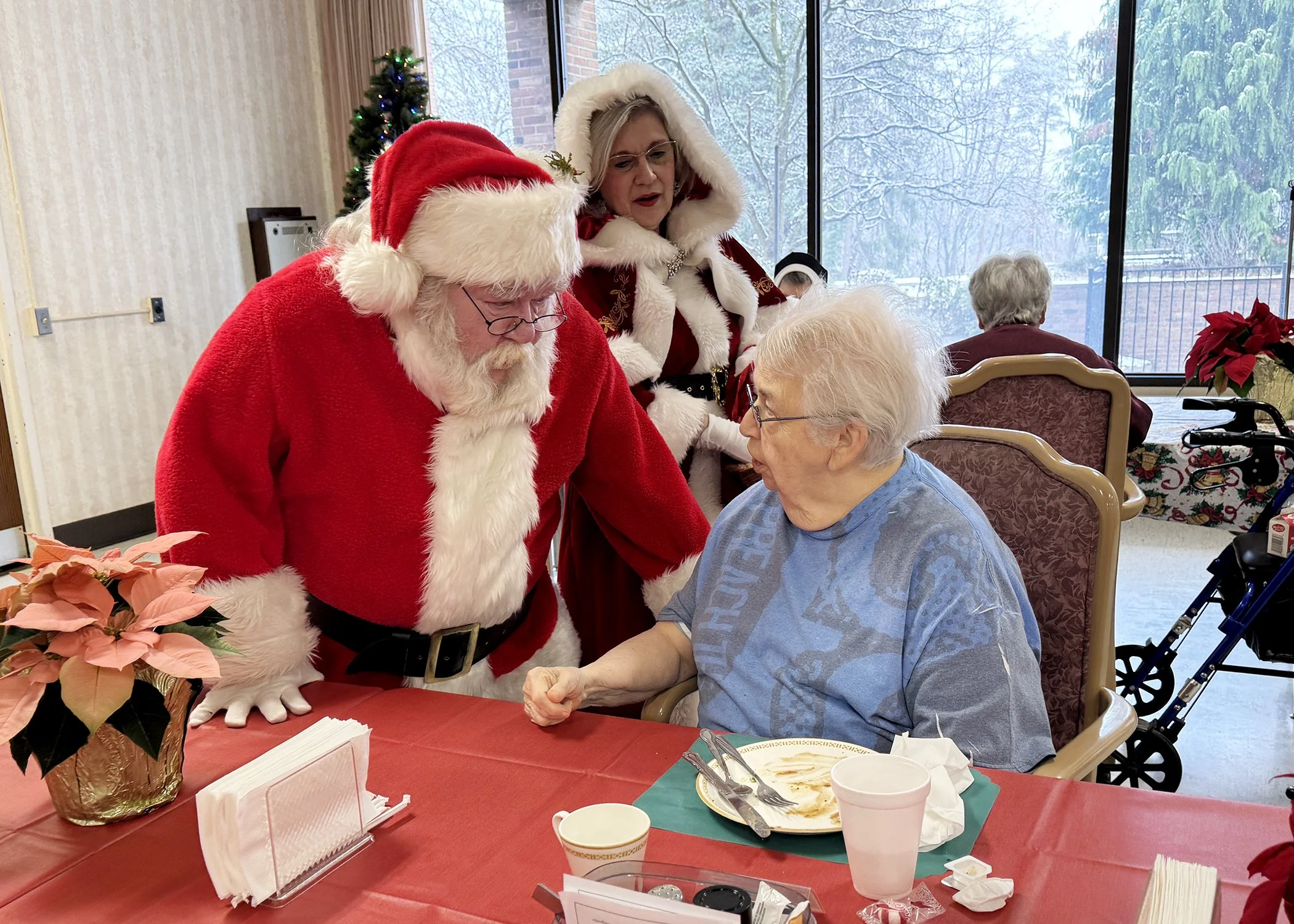  Sister Barbara Ann Webster pleads her case to Santa Claus during the Resident Christmas Party at Mt. Assisi Place on December 20, 2024. 