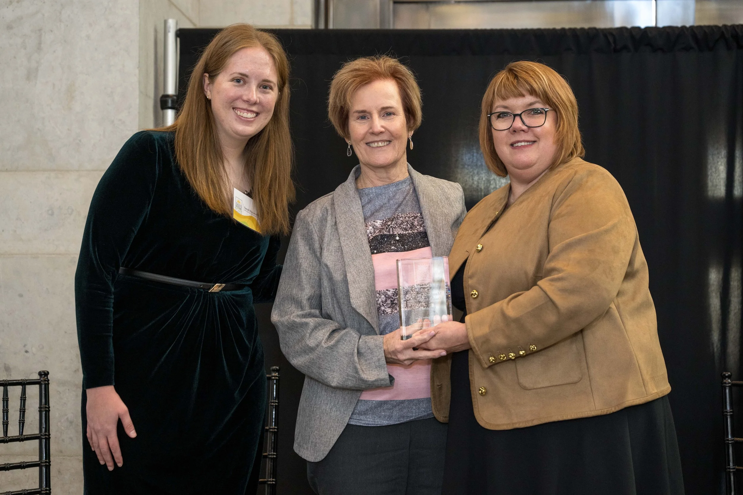  Sarah Hudacek, ODM Director Maureen Corcoran, and Teresa Lampl pose with Director Corcoran’s Champion for Ohio Families Award. 
