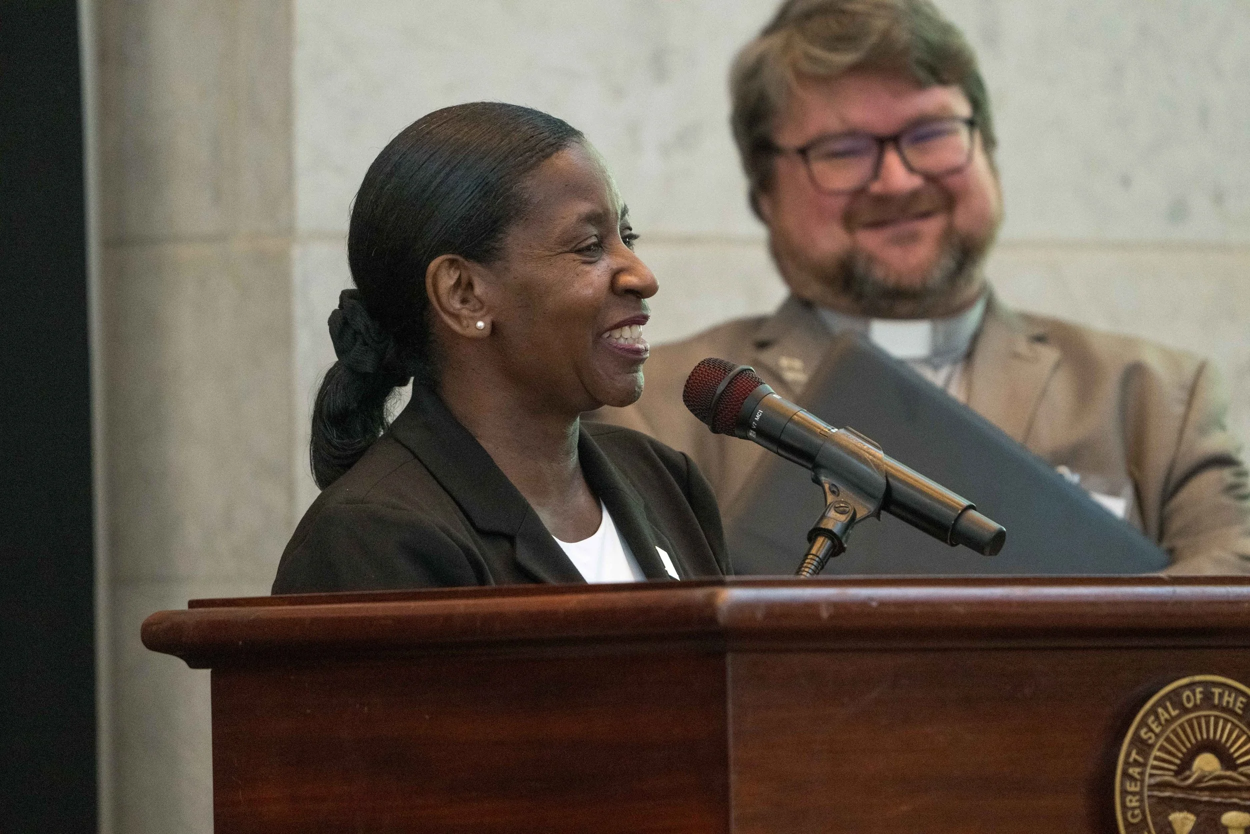  Charlotte Rudolph co-hosts the 15th Anniversary luncheon, with co-host Nick Bates looking on. 