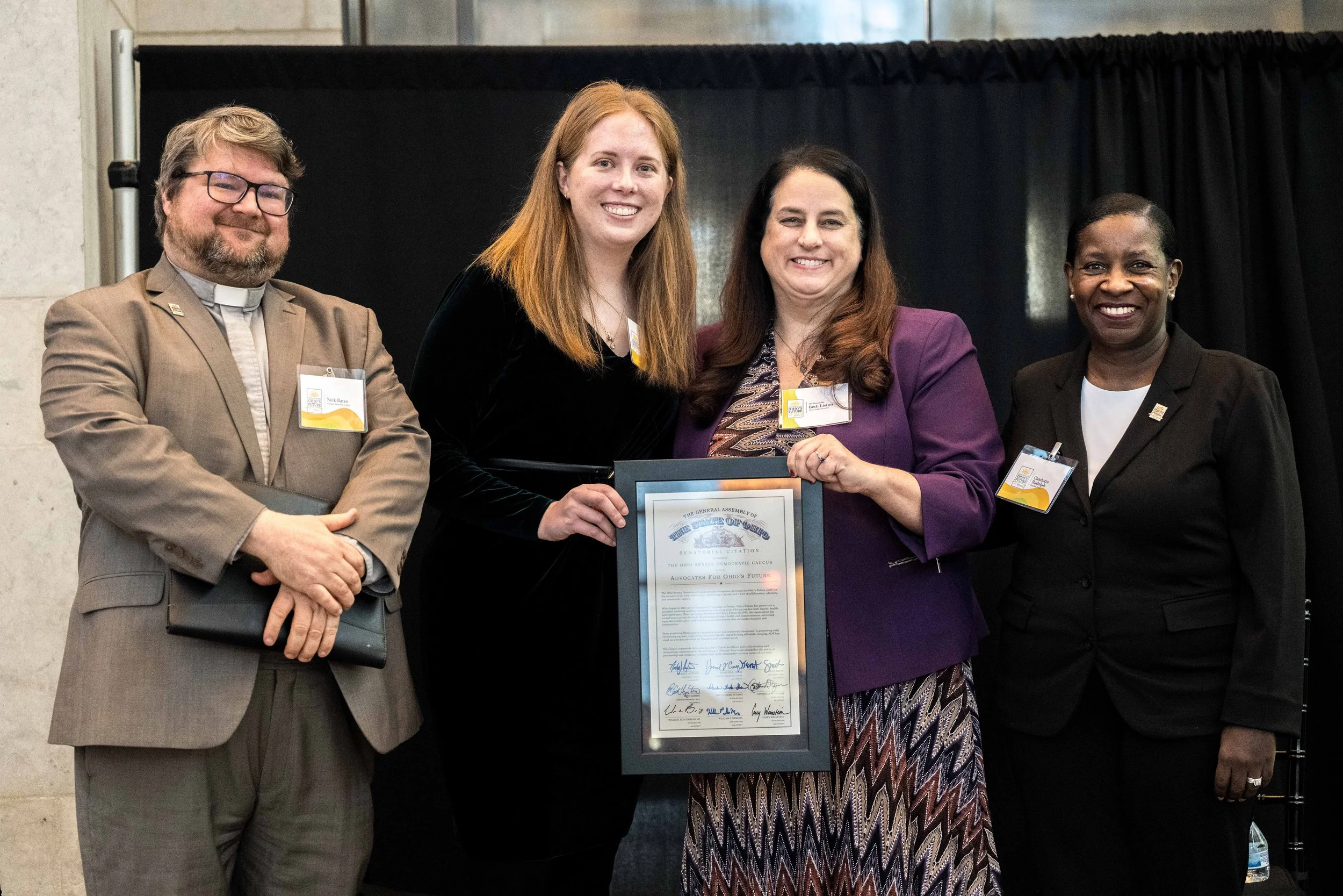  Nick Bates, Sarah Hudacek, State Senator Beth Liston, and Charlotte Rudolph pose with Senator Liston’s Senatorial Citation on behalf of the Senate Minority Caucus honoring AOF’s 15th Anniversary. 