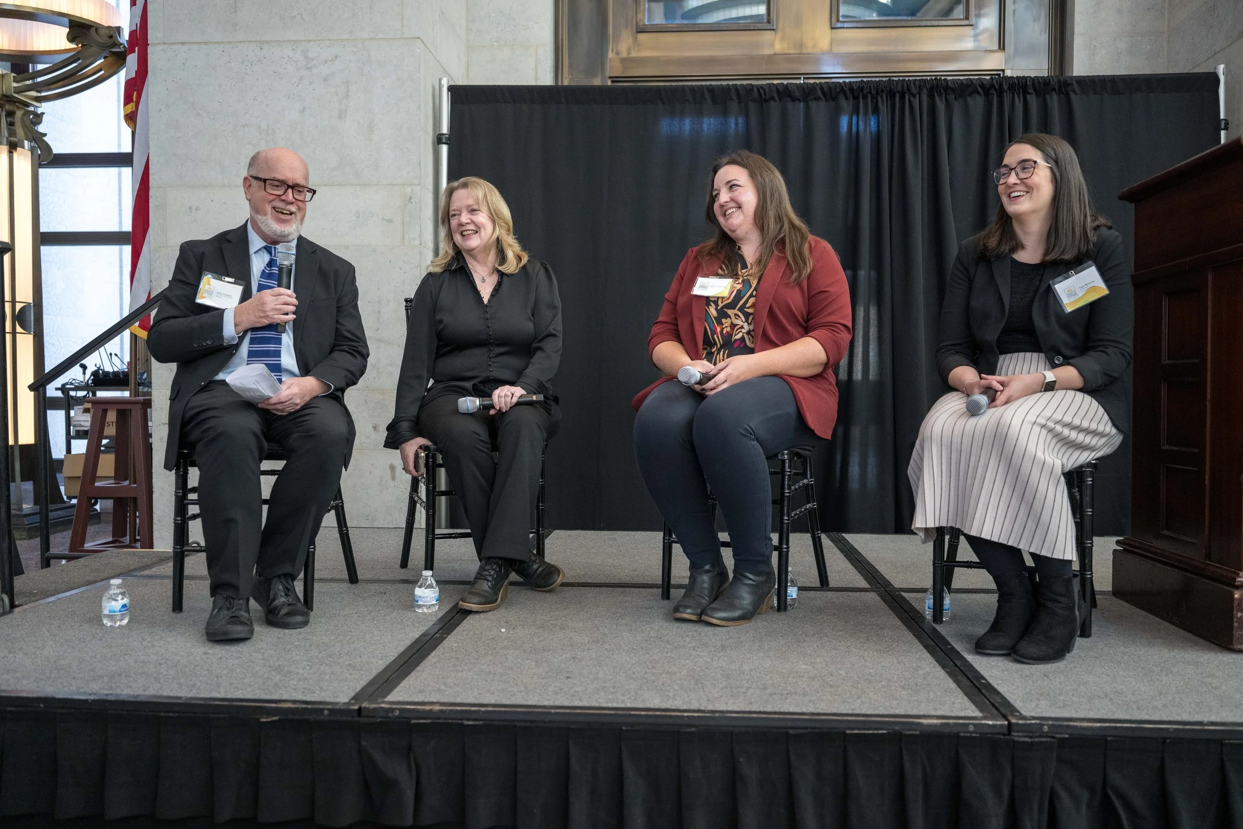  John Corlett, Marcia Egbert, Joree Novotny, and Tara Britton in a fireside chat on stage about coalition work and HHS advocacy. 