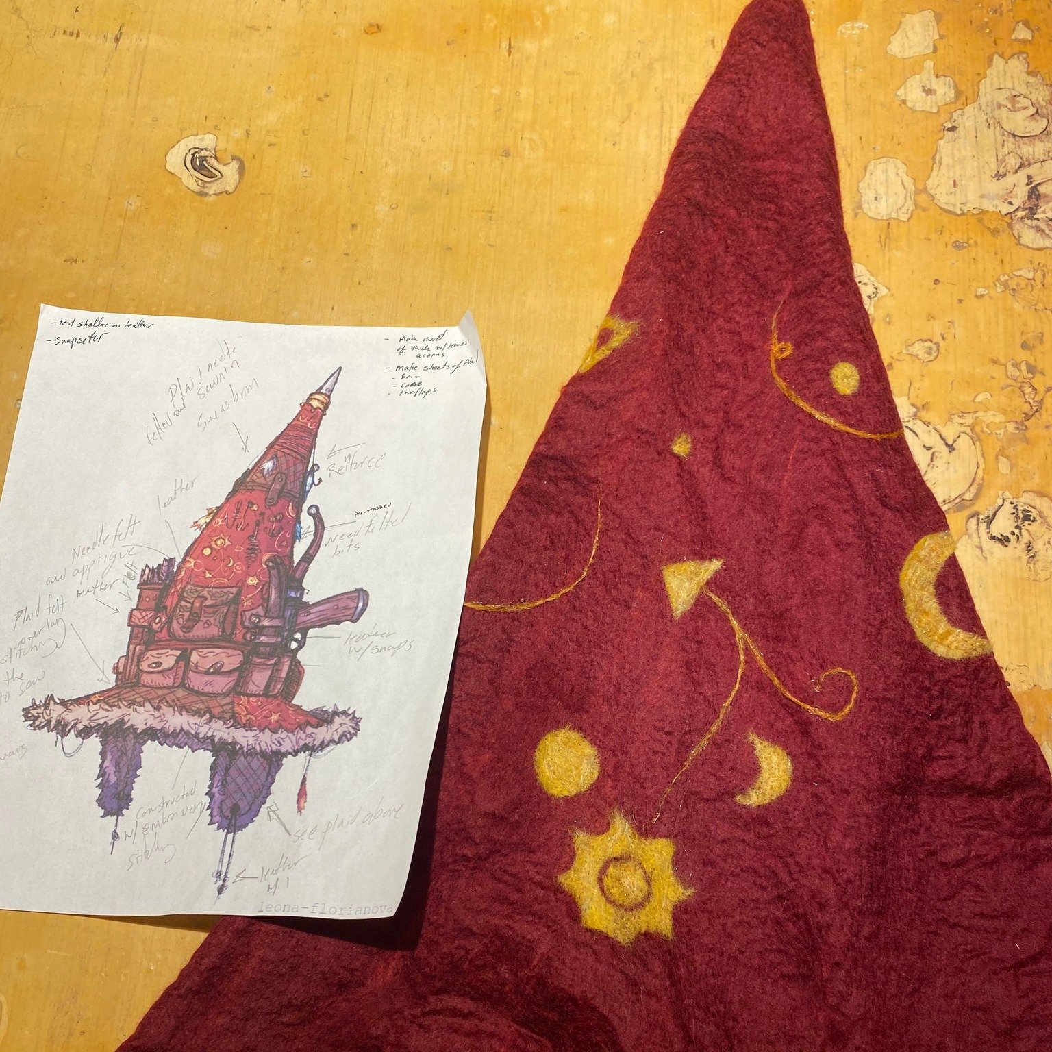Mustrum Ridcully Hat WIP update #2.  Once the body of the hat was  partially felted, I needle-felted a star and moon pattern into the surface.  You can see how the overlays for the brim I was working on in the last post turned out.  I roughed them in