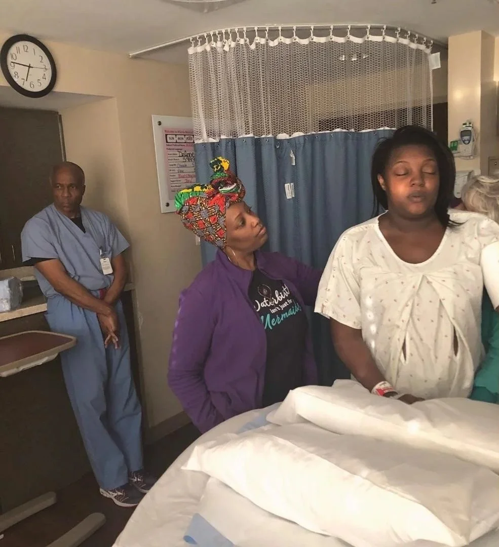 Black woman laboring with Black doula