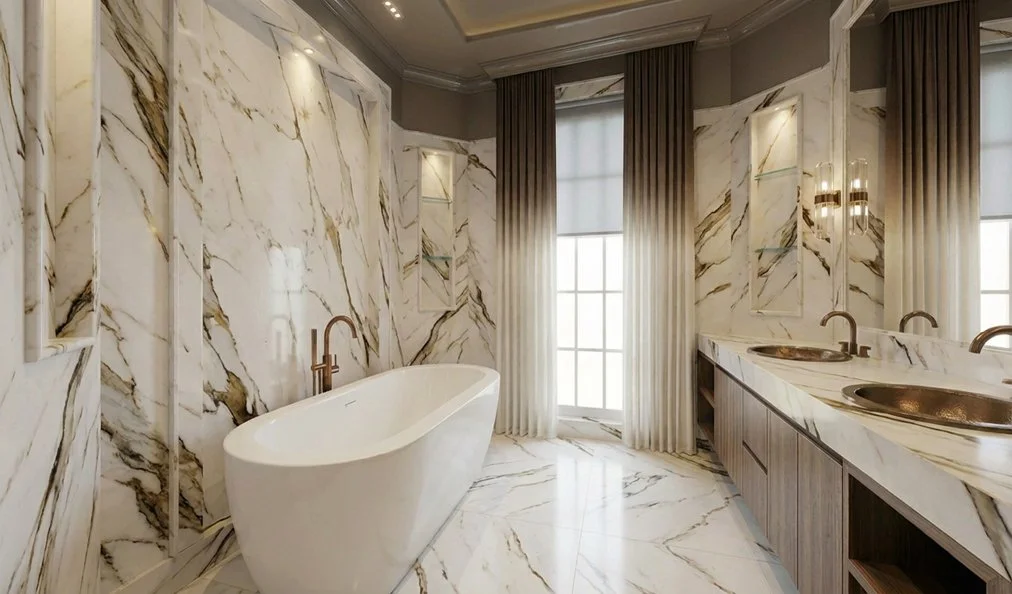 a marble veined primary bathroom with custom vanity and built in lighting.