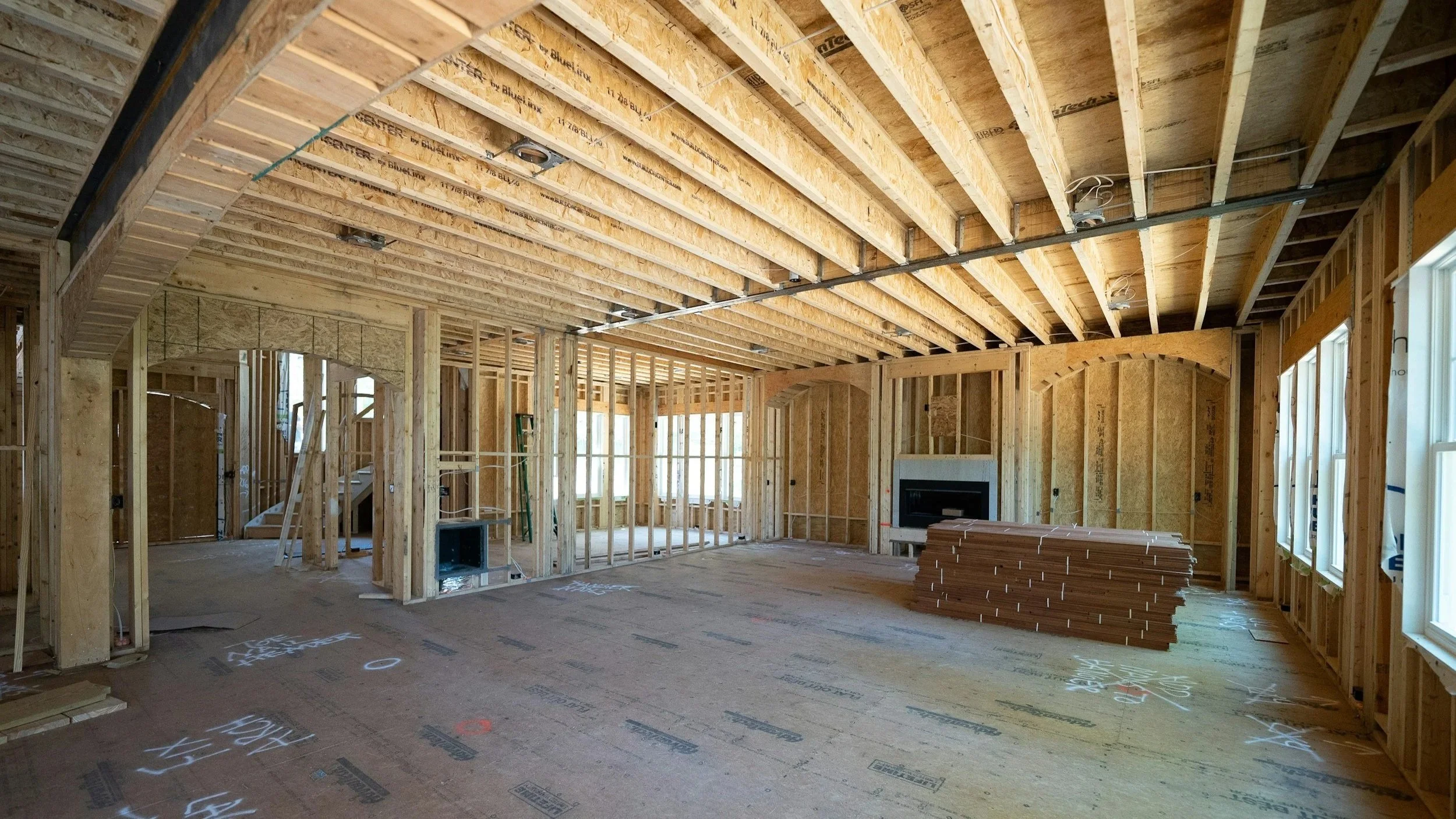 Architect and construction team reviewing design details during a residential site visit.