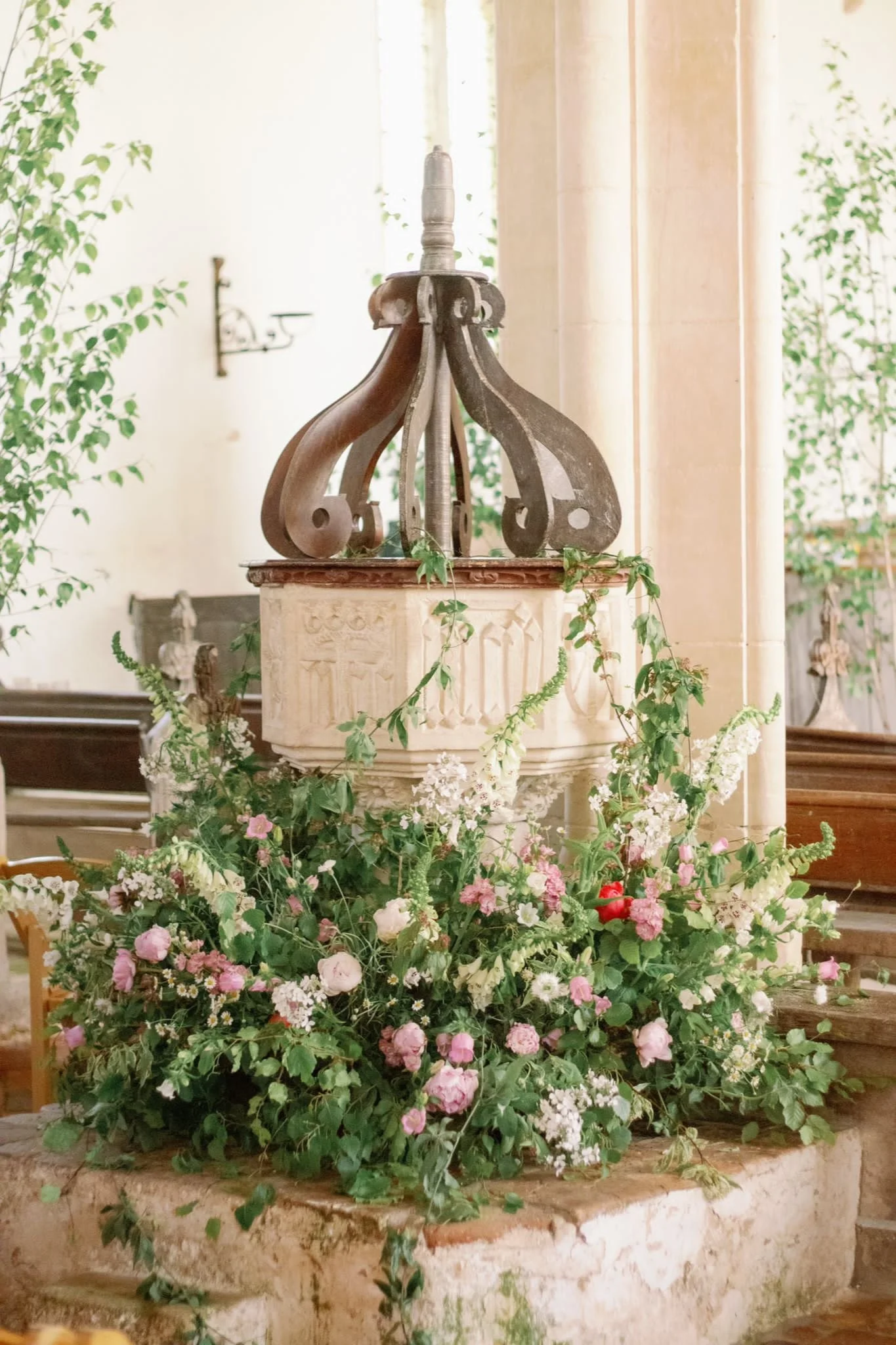 Izzy & Roly — Norfolk family church wedding with peony-rich doorway arch